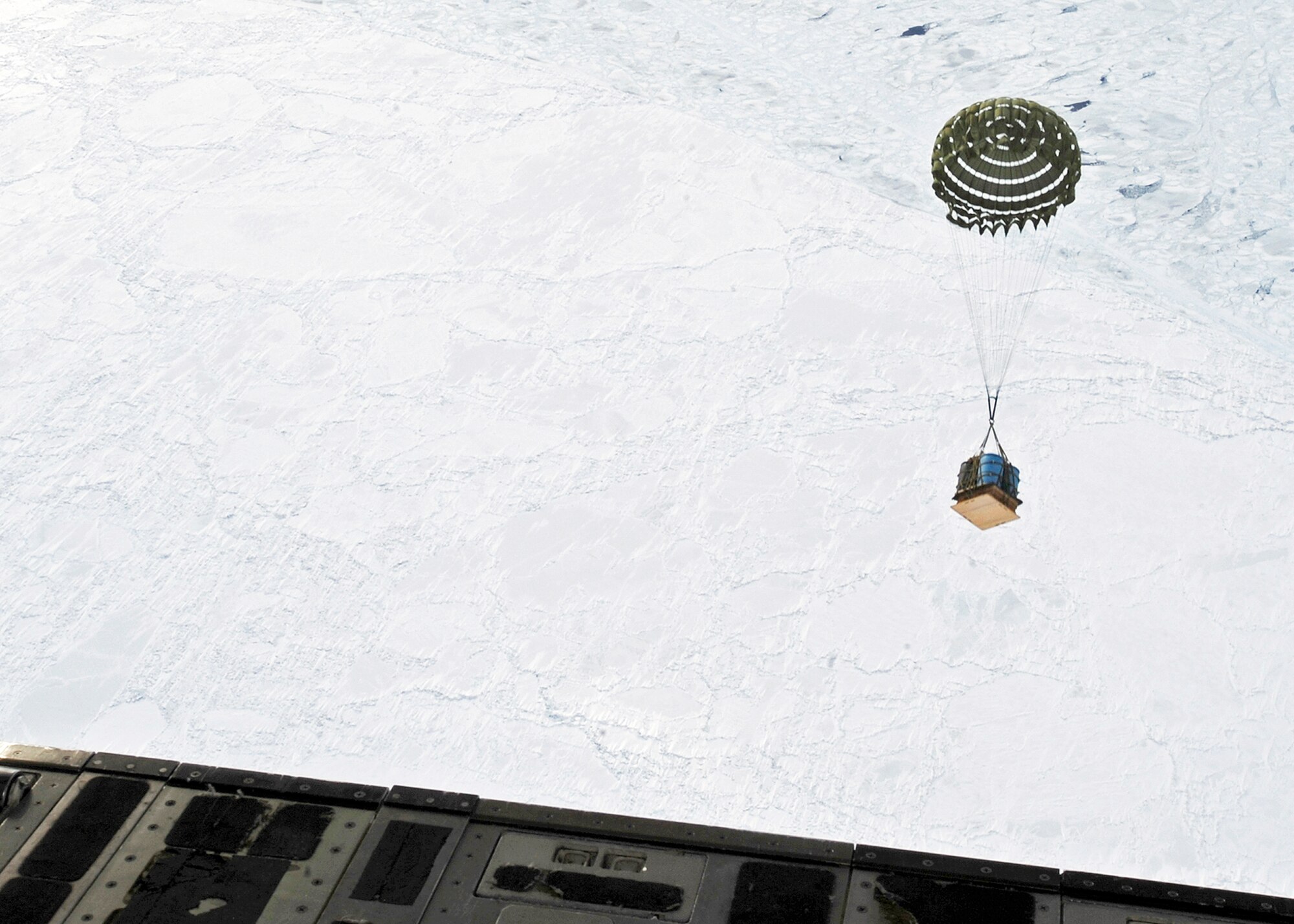 A crate of water is dropped from a C-17 Globemaster III March 19, 2010, at Elmendorf Air Force Base, Alaska. An aircrew from the 517th Airlift Squadron participated in a combat simulation improved container delivery drop over Tin City, Alaska. (U.S. Air Force photo/Senior Airman Matt Coleman-Foster)