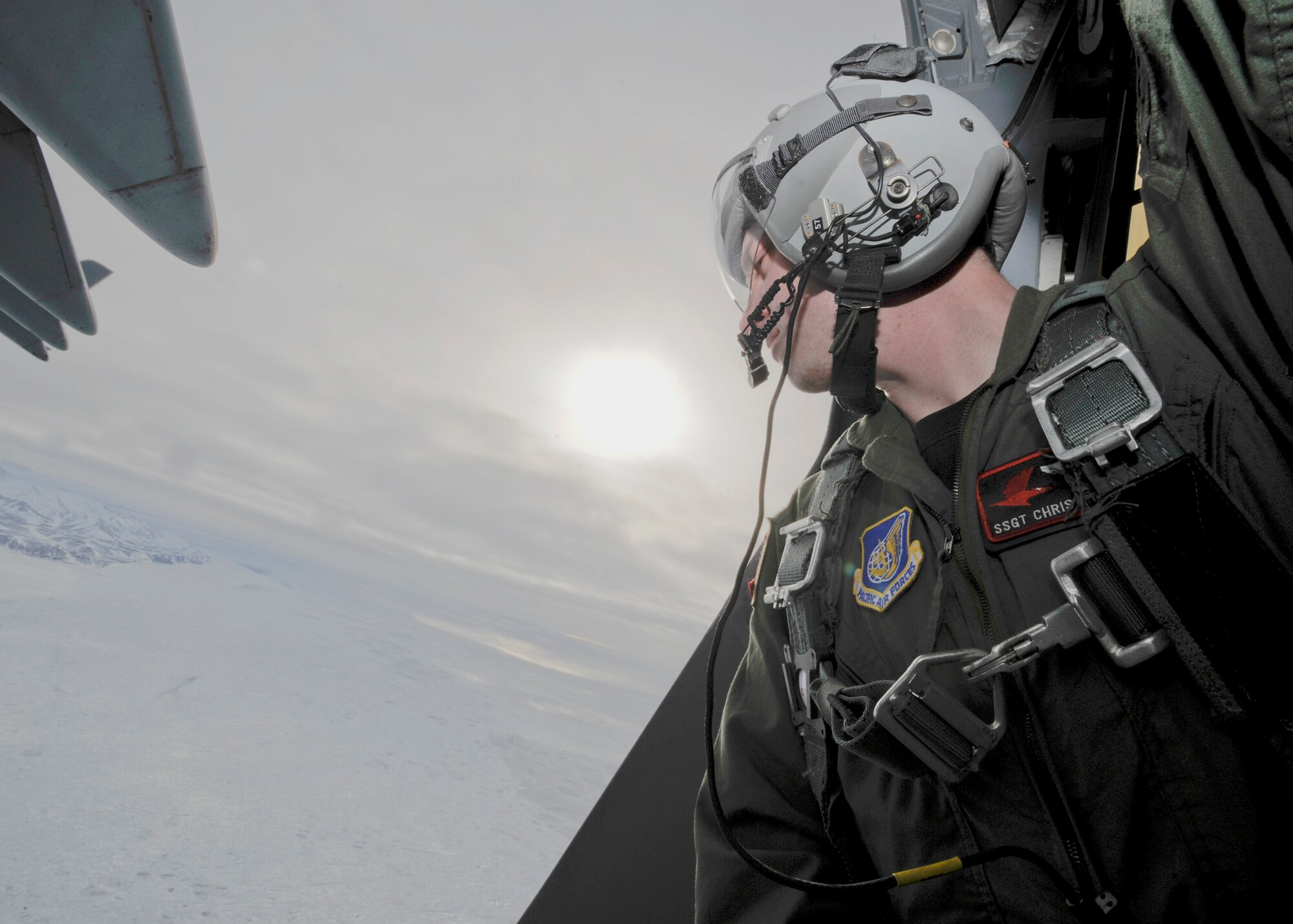 Staff Sgt. Chris McKnight checks his drop zone before deploying a sonde transmitter March 19, 2010, at Elmendorf Air Force Base, Alaska. Sergeant McKnight and his crew from the 517th Airlift Squadron participated in a combat simulation improved container delivery drop over Tin City, Alaska. (U.S. Air Force photo/Senior Airman Matt Coleman-Foster)