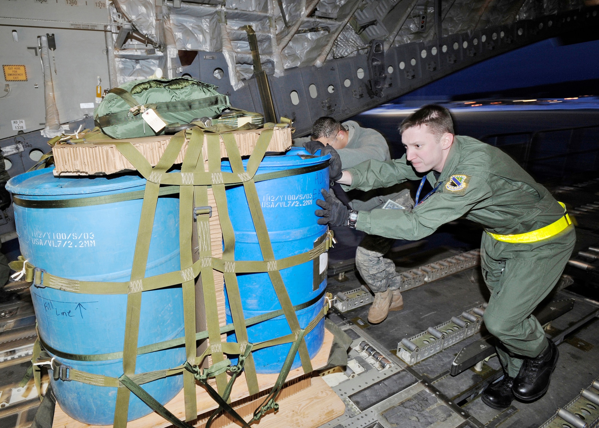 Staff Sgt. Chris McKnight and members of the 517th Aircraft Maintenance Unit load a water crate onto a C-17 Globemaster III March 19, 2010, at Elmendorf Air Force Base, Alaska. Sergeant McKnight and his crew from the 517th Airlift Squadron participated in a combat simulation improved container delivery drop over Tin City, Alaska. (U. S. Air Force photo/Senior Airman Matt Coleman-Foster)