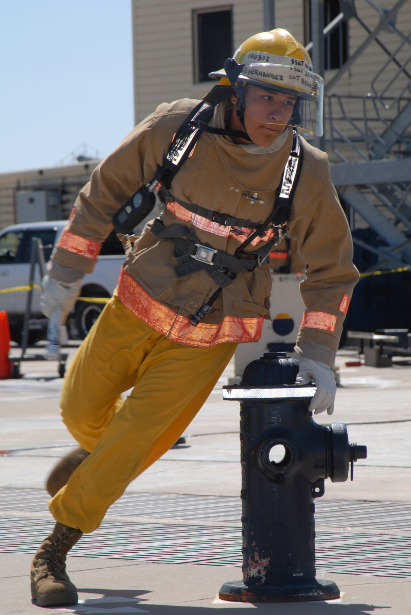 GOODFELLOW AIR FORCE BASE, Texas -- Army Pfc. Christoval Hernandez, 344th Military Intelligence Battalion, runs through a fire hydrant obstacle course during the rookie firefighter challenge, March 27, 2010. The challenge is a competition in which teams and individuals are pushed to their physical limits doing various firefighting exercises and was open to everyone on base. (U.S. Air Force photo/Staff Sgt. Laura R. McFarlane)
