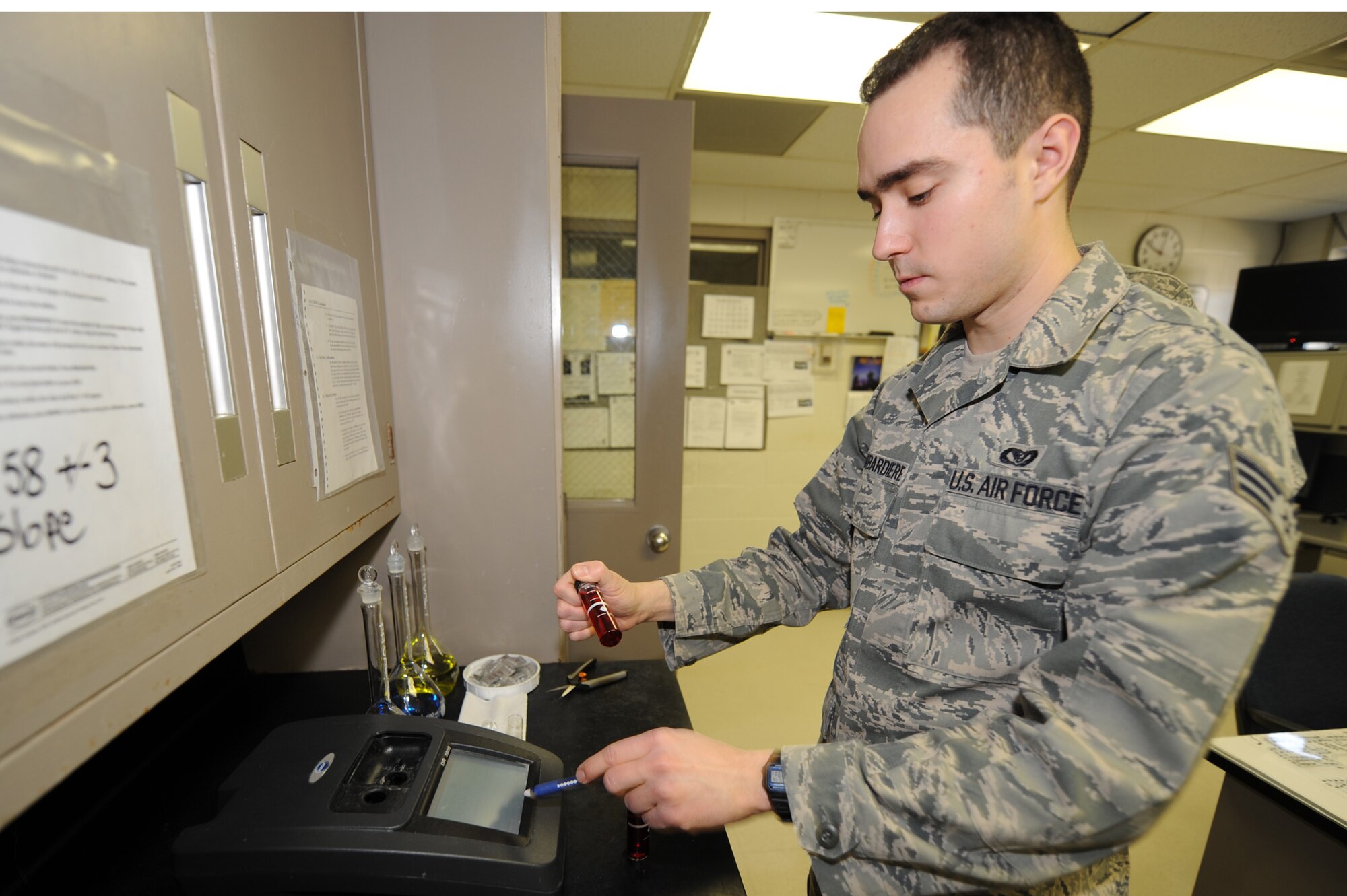 WHITEMAN AIR FORCE BASE, Mo. - Senior Airman Ryan Bombardiere, 509th Civil Engineer Squadron water treatment plant operator, runs a fluoride test on three  samples pulled from locations around the plant, March 29, 2010. The water treatment facility here goes beyond what Missouri Department of Natural Resources requires, ensuring the highest quality water for Team Whiteman. (U.S. Air Force photo/Airman 1st Class Carlin Leslie)  (Released)
