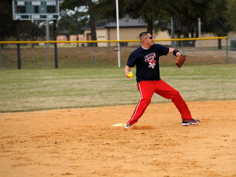 MOODY AIR FORCE BASE, Ga. -- Master Sgt. Robert Adams, 23rd Equipment Maintenance Squadron ammunitions accountability, throws a softball in an attempt to make the play at first base March 27. The 23rd EMS munitions flight were the champions of this tournament after having a slow start. For their win, they earned a trophy to be placed at their squadron. (U.S. Air Force photo Airman 1st Class Joshua Green)
