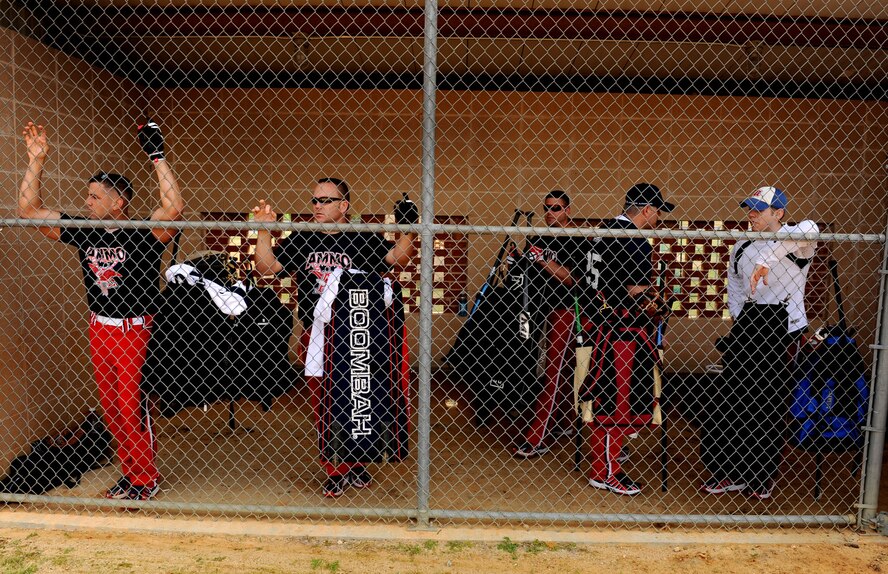 MOODY AIR FORCE BASE, Ga. -- Airmen from the 23rd Equipment Maintenance Squadron munitions flight, look out to the field from the dugout during the "Battle of the Base" softball tournament here March 27. The third annual tournament consisted of seven teams who raised more than $900 in a single day of playing softball. This was a all day double-elimination tournament with the first game beginning at 9:15 a.m. and the last game at 7:30 p.m. (U.S. Air Force photo Airman 1st Class Joshua Green)
