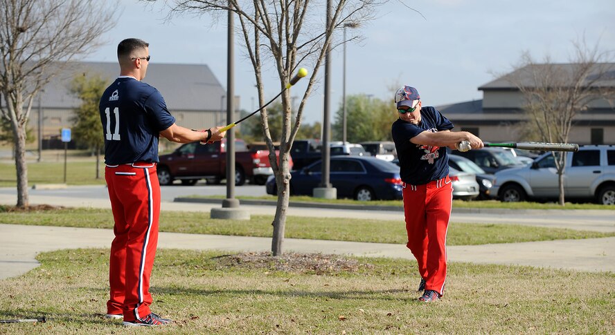 MOODY AIR FORCE BASE, Ga. -- Tech Sgts. Bryan Tkacs and Bryan Roberts, 23rd Equipment Maintenance Squadron munitions accountability, warm up before a softball tournament using a hit stick here March 27. The 23rd EMS munitions flight team competed in this double-elimination tournament, during which they were the champions. (U.S. Air Force photo Airman 1st Class Joshua Green)