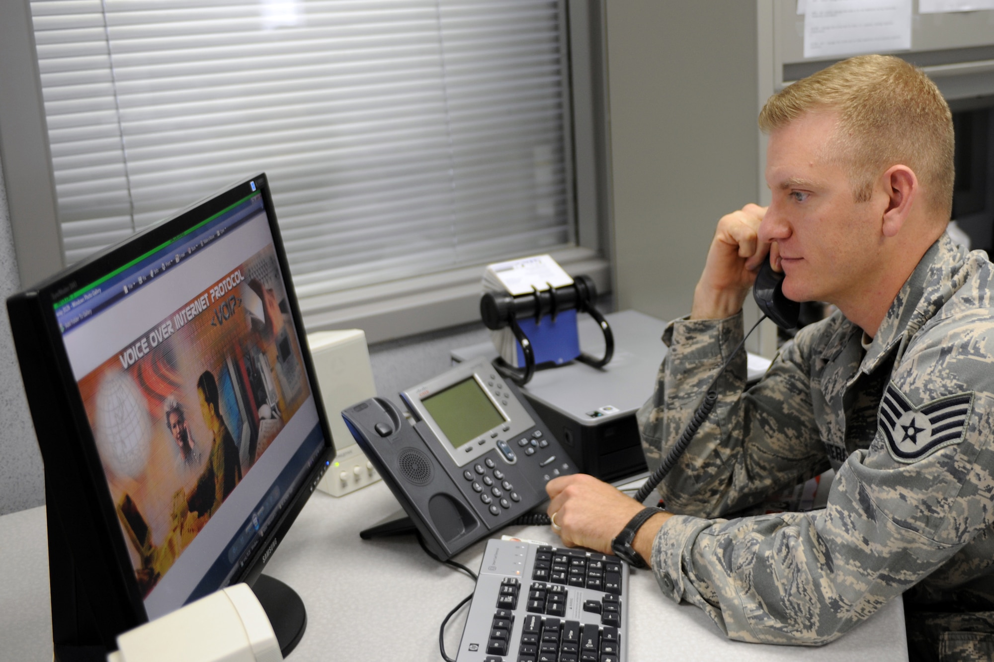WHITEMAN AIR FORCE BASE, Mo., --Staff Sgt. Matthew, Ruggiero 509th Communications Squadron communication project manager, demonstrates how to use the new Voice over Internet Protocol phone that will be introduced here, starting early April 2010. VoIP equipment allows voice communication to travel over the Internet to its destination instead of a regular telephone landline. (U.S. Air Force photo/Staff Sgt. Jason Huddleston) (Released)