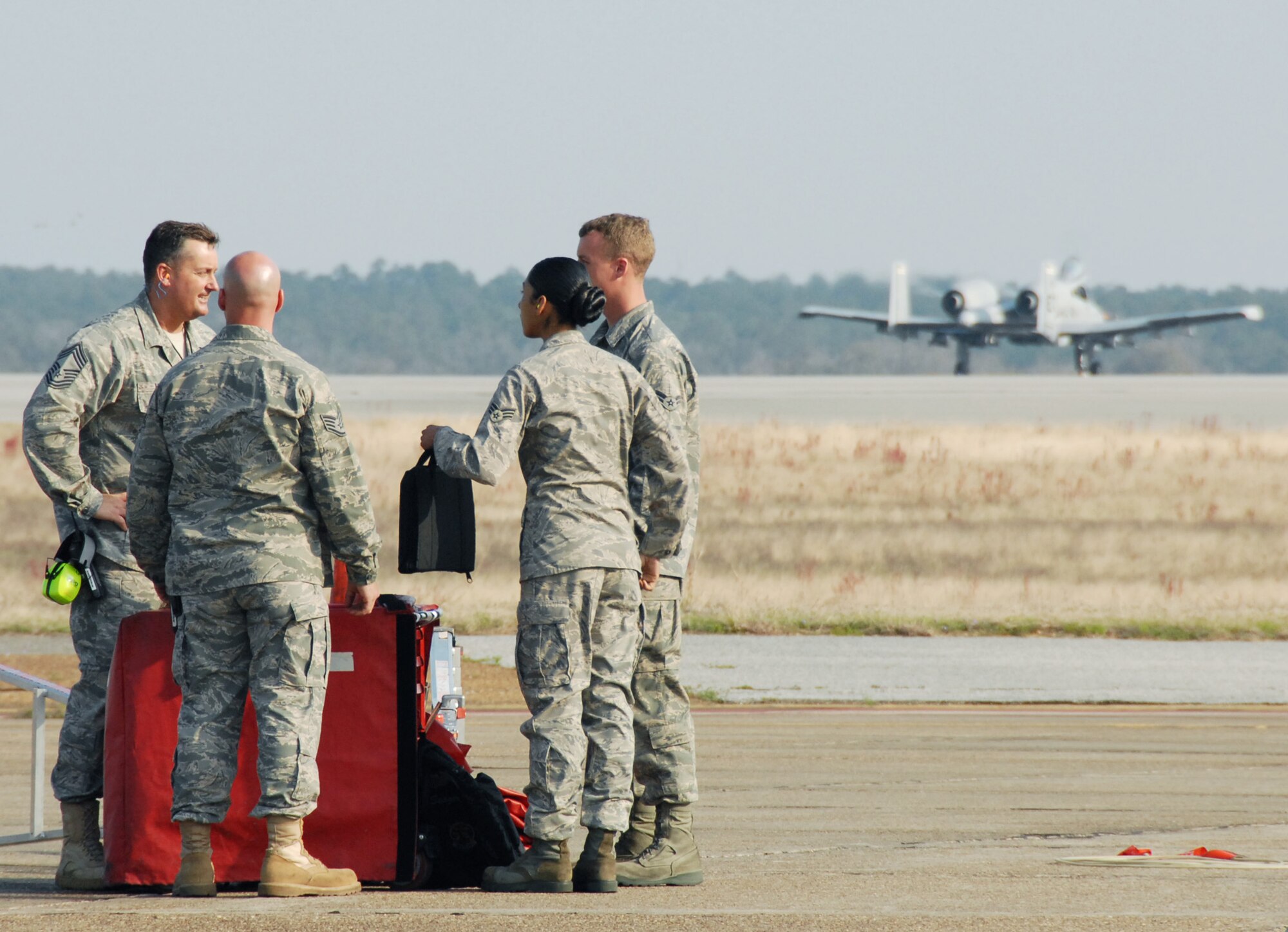 Chief Master Sgt. Donnie Morris, 46th Test Wing, congratulates the ground crew as their A-10C Thunderbolt II rolls toward take-off March 25 at Eglin Air Force Base, Fla. Aircraft maintainers in the 46th Test Wing work on F-16s, F-15s, A-10s, C-130s and even UH-1s.  They maintain both the 46th TW aircraft, but also the 53rd Wing's aircraft. (U.S. Air Force photo/Samuel King Jr.)  