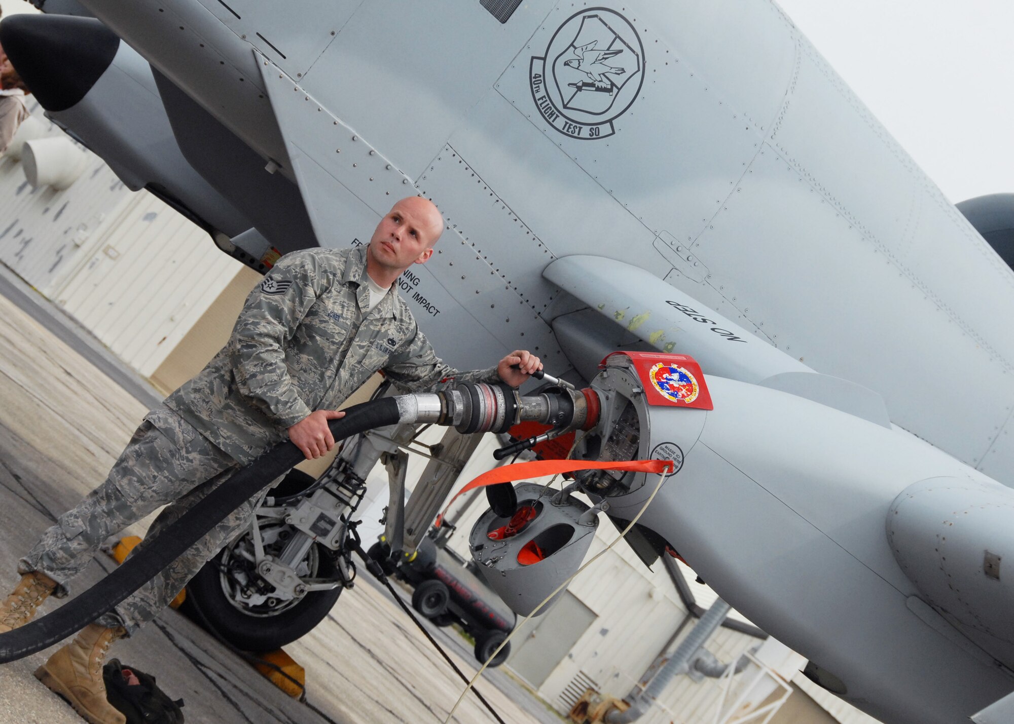 Staff Sgt. Rusty Jones, 46th Aircraft Maintenance Squadron crew chief, looks for word from the fuel specialist to know when the A-10C Thunderbolt II has received the right amount of fuel March 24 at Eglin Air Force Base, Fla. Aircraft maintainers in the 46th Test Wing work on F-16s, F-15s, A-10s, C-130s and even UH-1s.  They maintain both the 46th TW aircraft, but also the 53rd Wing's aircraft. (U.S. Air Force photo/Samuel King Jr.)