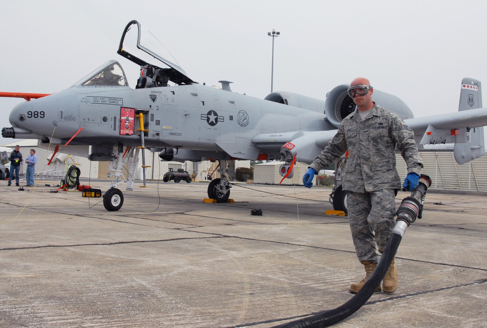 Staff Sgt. Rusty Jones, 46th Aircraft Maintenance Squadron crew chief, helps reel in the fuel hose after filling up the tanks on an A-10C Thunderbolt II has received the right amount of fuel March 24 at Eglin Air Force Base, Fla. Aircraft maintainers in the 46th Test Wing work on F-16s, F-15s, A-10s, C-130s and even UH-1s.  They maintain both the 46th TW aircraft, but also the 53rd Wing's aircraft. (U.S. Air Force photo/Samuel King Jr.)