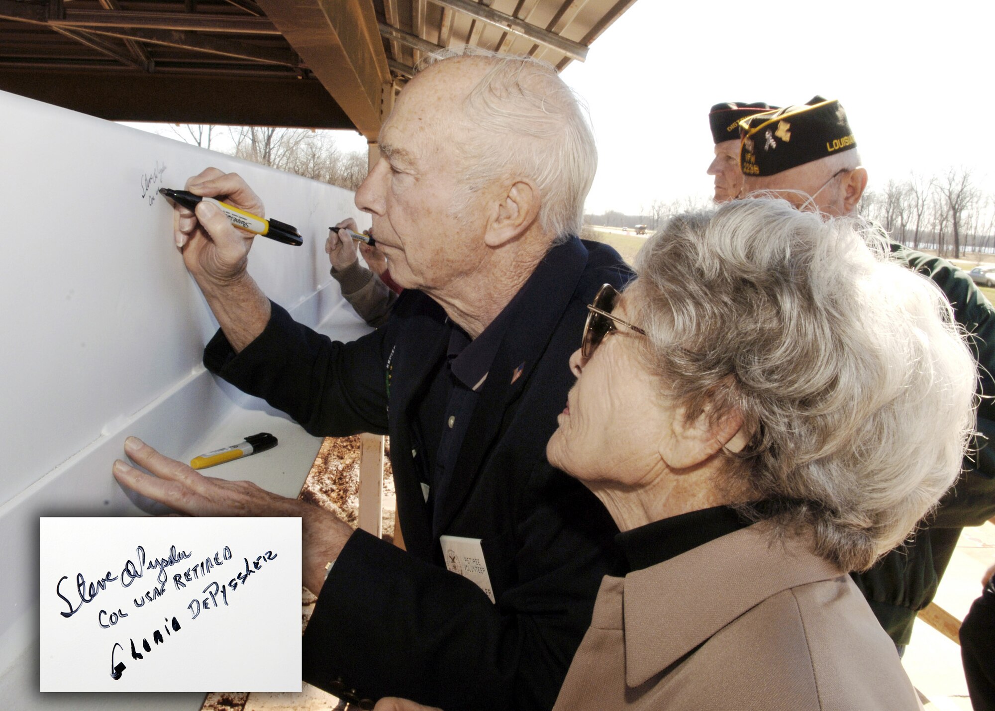 Retired Col. Steve dePyssler and his wife Gloria sign a beam Jan. 25, 2006, during the capping ceremony for the Louisiana War Veterans Home in Bossier City, La.  Colonel dePyssler was instrumental in bringing the project to fruition. (U.S. Air Force photo illustration/Master Sgt. Michael Kaplan)