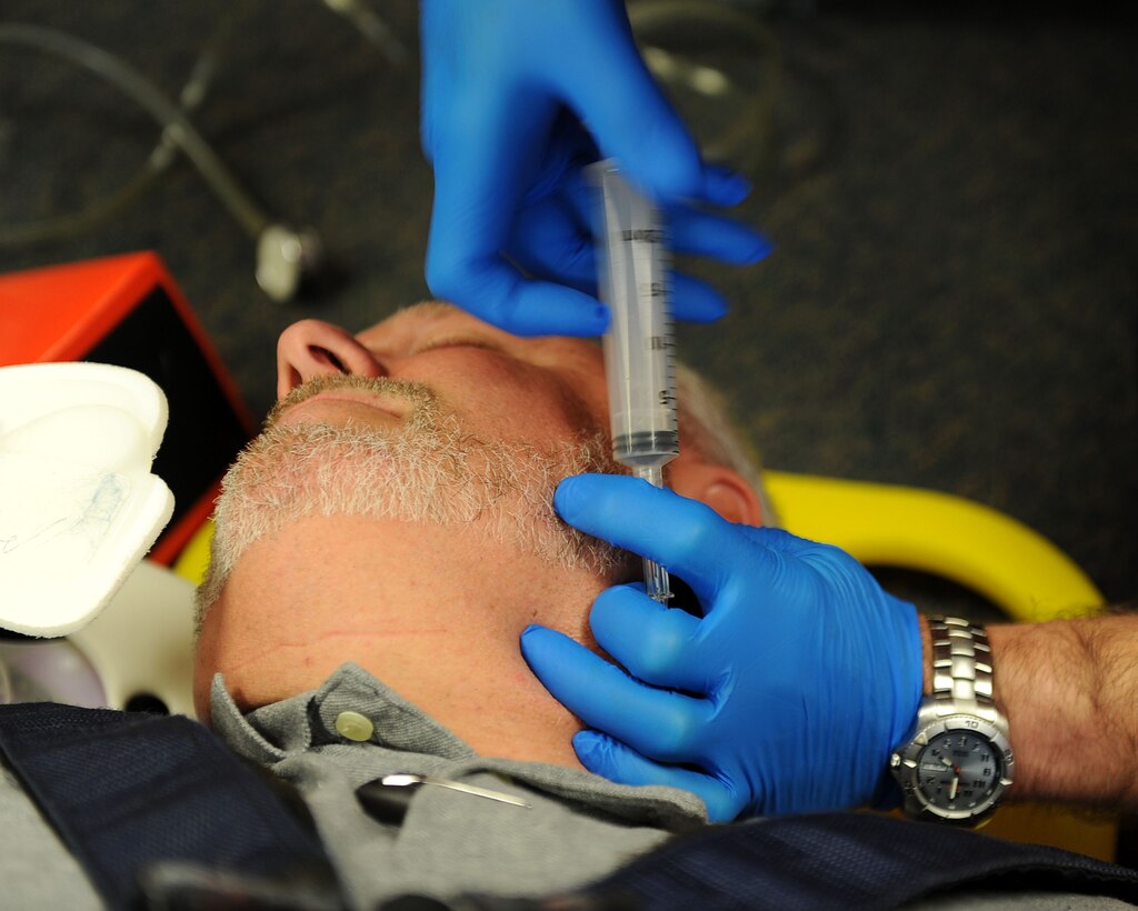 LANGLEY AIR FORCE BASE, Va. -- Paul Ruppert, 633d Medical Operations Squadron paramedic, simulates injecting cardiac drugs into David Ezzell Jr., 633d MDOS paramedic, during Pre-Hospital Trauma Life Support training March 29.  Paramedics undergo extensive training to ensure they are qualified to perform the duties assigned to them. (U.S. Air Force photo/Airman Rebecca Montez)