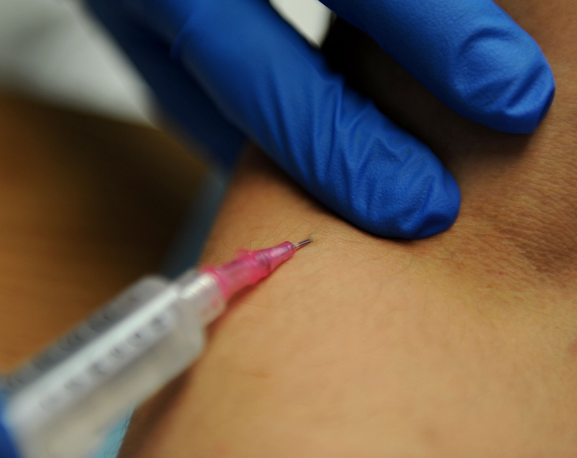 LANGLEY AIR FORCE BASE, Va. - 2nd Lt. Travis Schaffer, 633d Medical Operations Squadron clinical nurse, inserts an I.V. into a patient’s vein at the USAF Hospital Langley Urgent Care Center March 29. This is a task that is often performed by paramedics either at the scene of an incident, en route to the hospital or upon arrival. (U.S. Air Force photo/Airman Rebecca Montez)