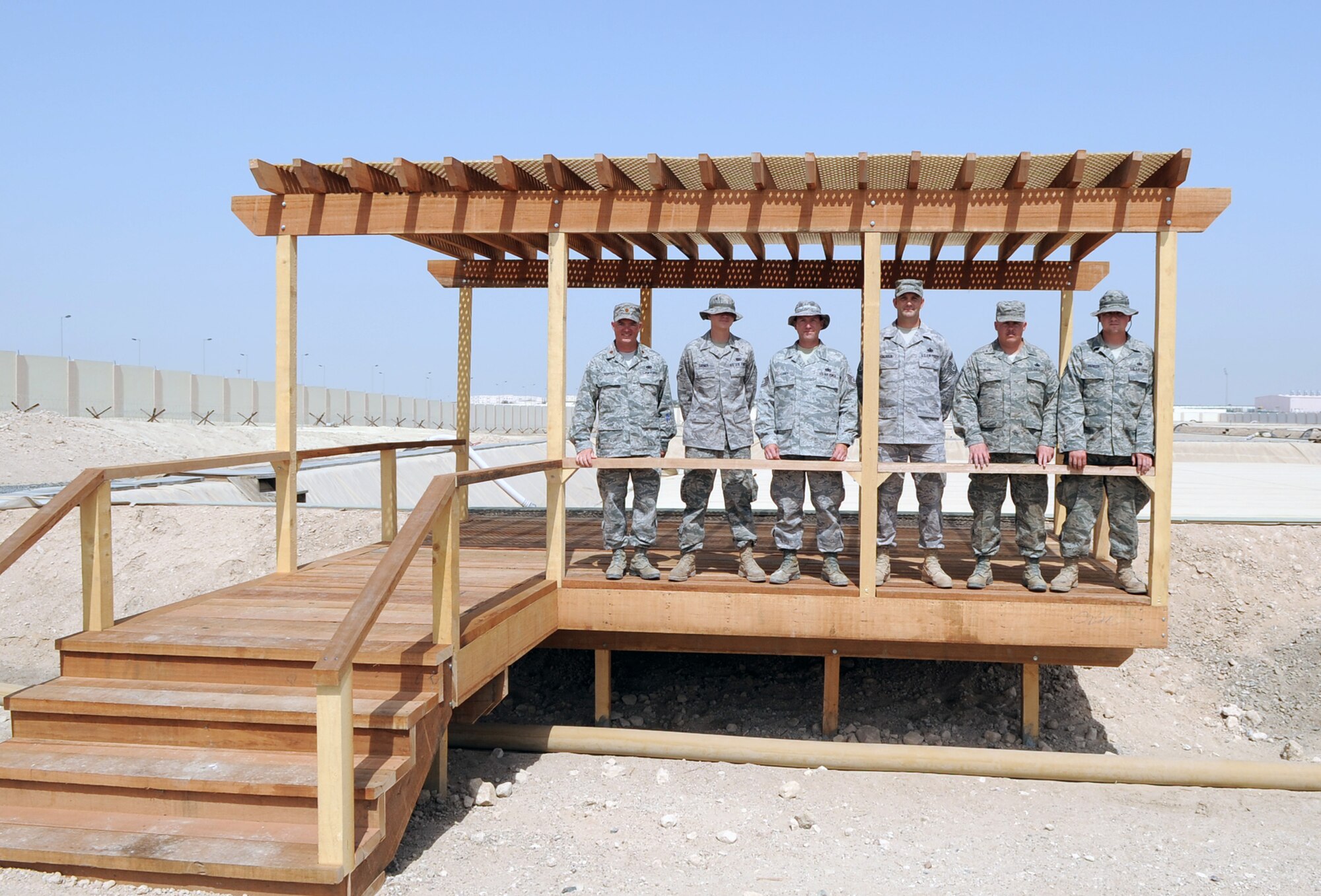 Maj. Michael L. Horsey (far left), director of operations for the 380th Expeditionary Logistics Readiness Squadron, stands with Airman 1st Class Kyle Turner, Tech. Sgt. Mark Carey, Senior Master Sgt. Jim Calhoun, Master Sgt. Charles Ellis and Staff Sgt. John Parker, all from the 380th ELRS fuels management flight, on the new viewing platform designed by Major Horsey at the fuels storage area at a non-disclosed base in Southwest Asia. (U.S. Air Force Photo/Master Sgt. Scott T. Sturkol/Released)