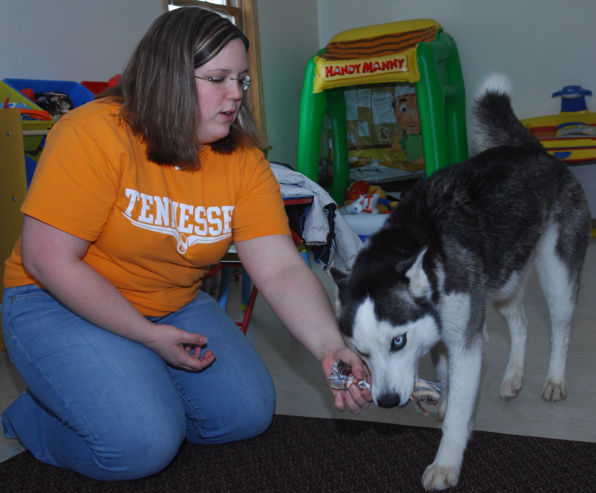 MINOT AIR FORCE BASE, N.D. -- Racheal Conley, wife of Airman 1st Class Aaron Conley, 5th Munitions Squadron, plays with her dog Bonnie in their home at Minot AFB March 25. Thanks to a microchip implanted in Bonnie, the family was reunited with her following a four-month, 1,500-mile journey from Los Angeles, Calif. (U.S. Air Force photo by Laurie Arellano)