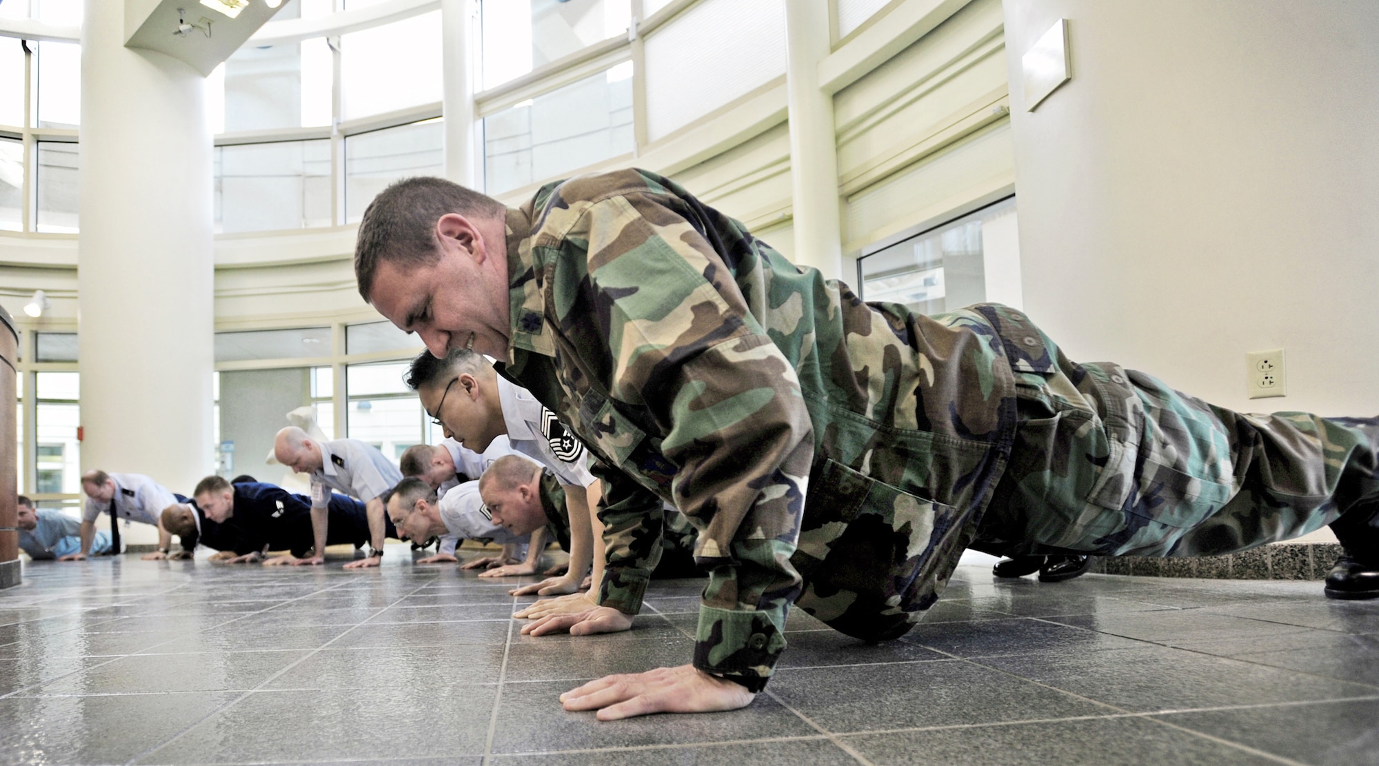 Lt. Col. Jeffrey Medland completes push-ups as part of the 100-day million push-up challenge March 29, 2010, at Elmendorf Air Force Base, Alaska. In an attempt to improve PT scores and unit camaraderie, 425 Elmendorf AFB Airmen did 1,184,957 push-ups in 100 days. Colonel Medland is assigned to the 3rd Medical Operations Squadron. (U.S. Air Force photo/Senior Airman Laura Turner)