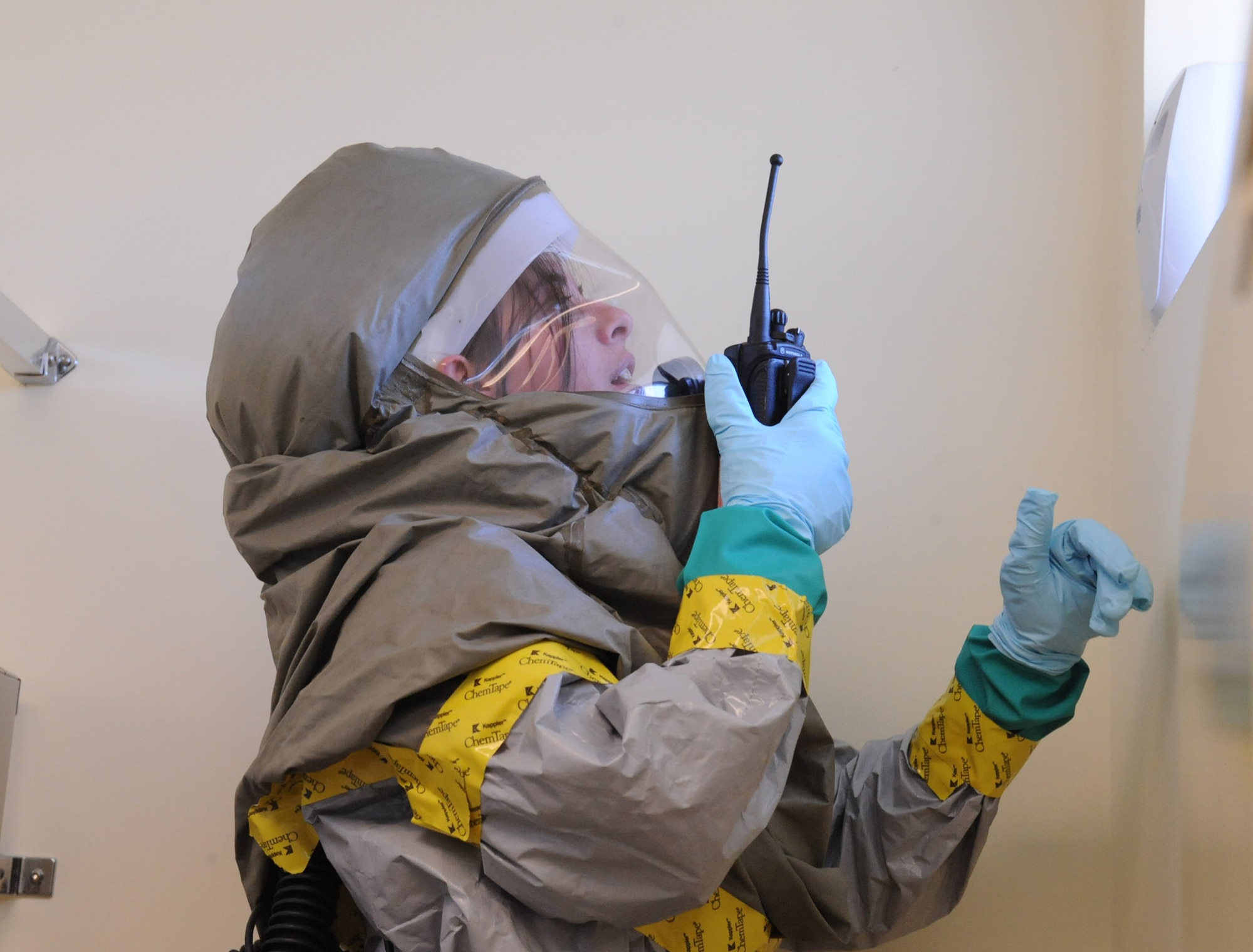 Staff Sgt. Evelyn Nicholson, 4th Medical Group emergency management craftsman, checks an aerospray can for abnormalities during a Chemical Biological Radiological Nuclear Explosive challenge on Seymour Johnson Air Force Base, N.C., March 23, 2010. Nicholson has to check every inch of a room before deeming it clear of hazardous substances. Nicholson is from Bath, N.Y. (U.S. Air Force photo/Senior Airman Whitney Lambert)