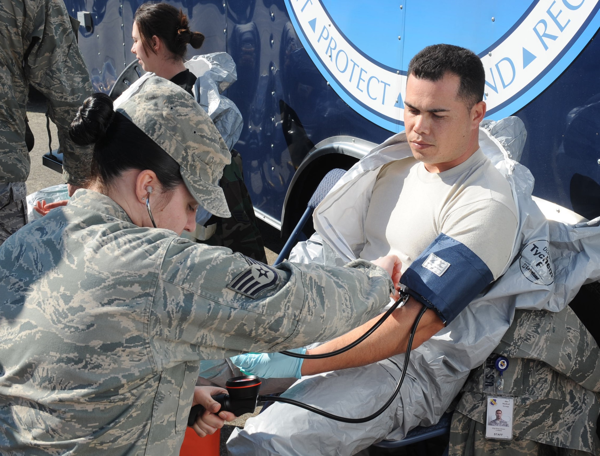 Staff Sgt. Candy Taylor, 4th Medical Group aerospace medicine technician, checks the blood pressure of Senior Airman Brain Moses, 4th Medical Group bioenvironmental engineering technician, before the Chemical Biological Radiological Nuclear Explosive challenge kicks-off on Seymour Johnson Air Force Base, N.C., March 23, 2010. Taylor checked Moses' blood pressure, respiration, heart rate and visual acvity to ensure he was medically clear to participate. Moses hails from Fayetteville, N.C., and Taylor is from Newport News, Va. (U.S. Air Force photo/Senior Airman Whitney Lambert)