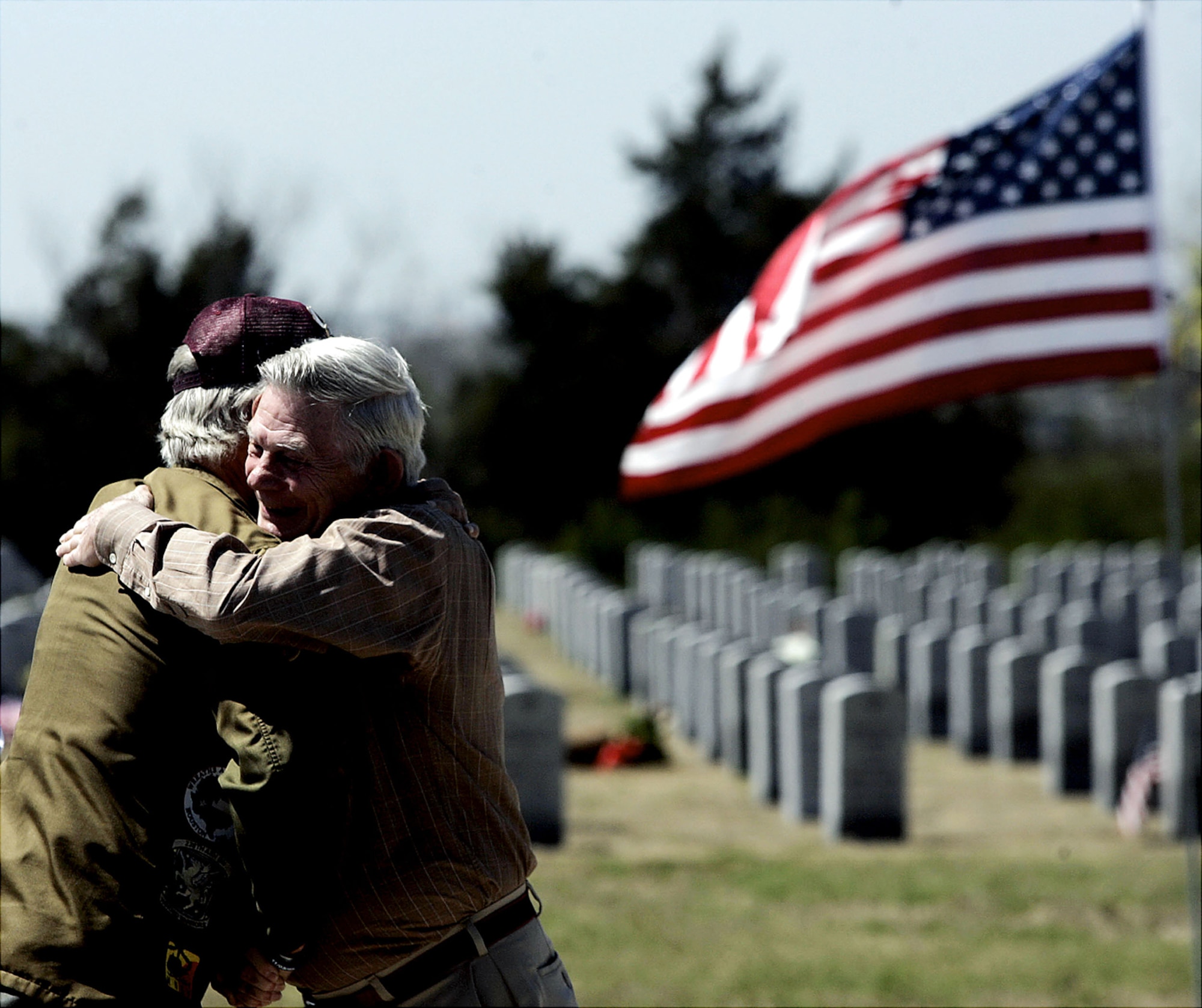 Vietnam veterans Jerry Turner, left, and Ray Hunziker hug at the funeral of Air Force Maj. Curtis Daniel Miller on Monday, March 29 in Dallas. Maj. Miller, of Palacios, Texas, was buried Monday afternoon at Dallas-Fort Worth National Cemetery, with full military honors. His funeral comes 38 years to the day after his gunship was shot out of the sky over Laos during the Vietnam War. His remains were processed at the Air Force Mortuary Affairs Operations Center at Dover Air Force Base, Del. (AP Photo/Mike Fuentes) 