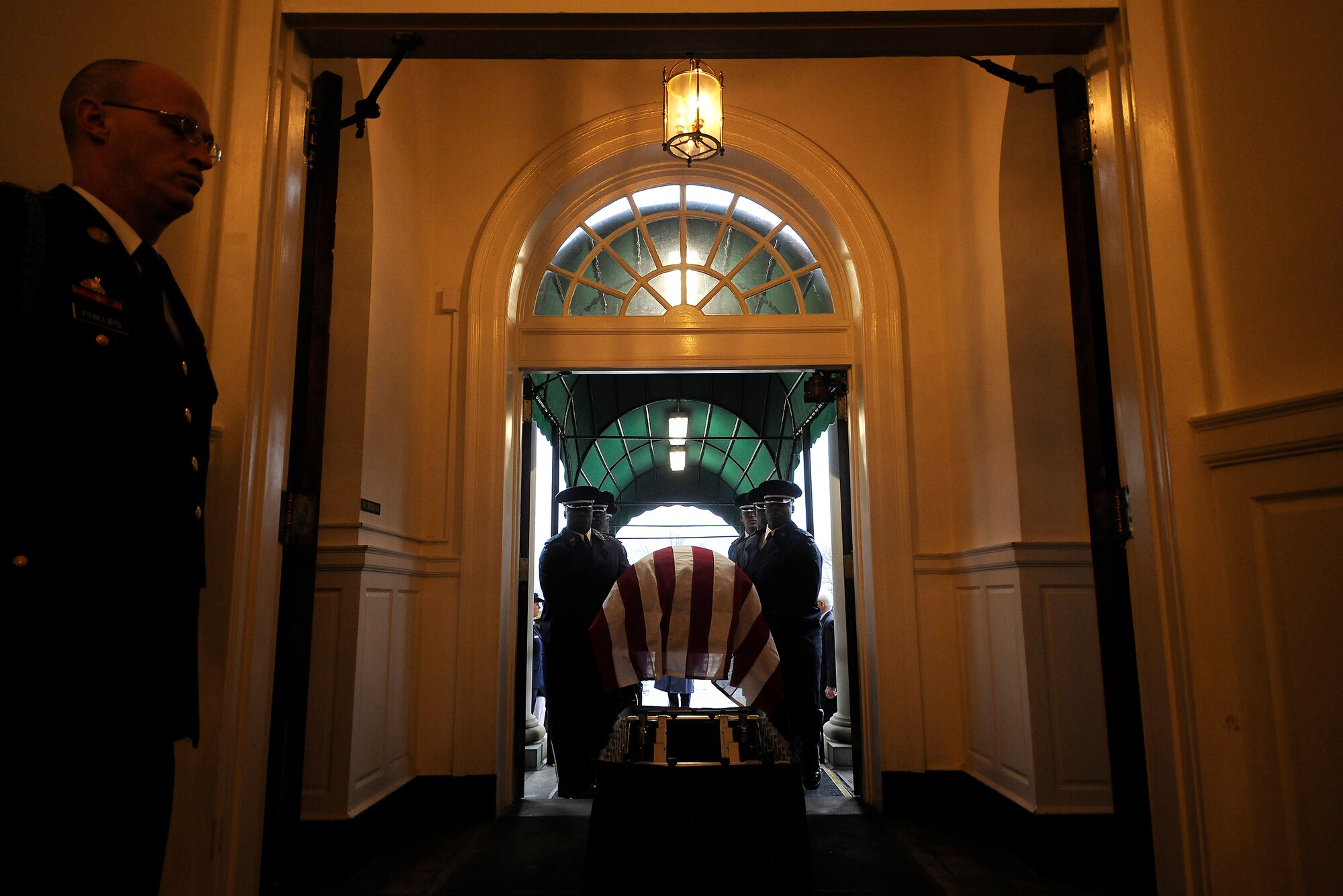 U.S. Air Force Honor Guard pall bearers carry the casket of Maj. Gen. Jeanne M. Holm into the Old Post Chapel on Joint Base Myer-Henderson Hall,  Va., near Arlington National Cemetery, March 29, 2010, before she was laid to her final rest in Arlington. General Holm, born in 1921, enlisted into the Women's Army Auxiliary Corps in 1942 and was commissioned a third officer -- a 2nd lieutenant equivalent -- in 1943.  (U.S. Air Force photo/Scott M. Ash)