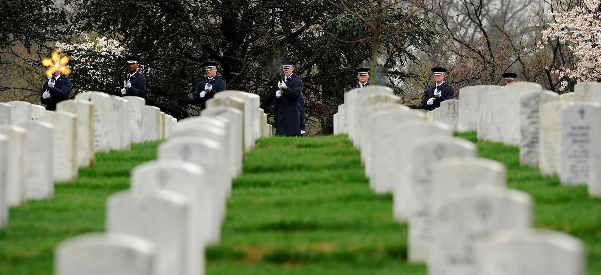 A U.S. Air Force Honor Guard detail fires a rifle volley March 29, 2010, during the full-honors funeral of Maj. Gen. Jeanne M. Holm in Arlington National Cemetery. She was promoted to major general with an effective date of July 1, 1970, and was the first woman in the Armed Forces to serve in that grade. (U.S. Air Force photo/Scott M. Ash)