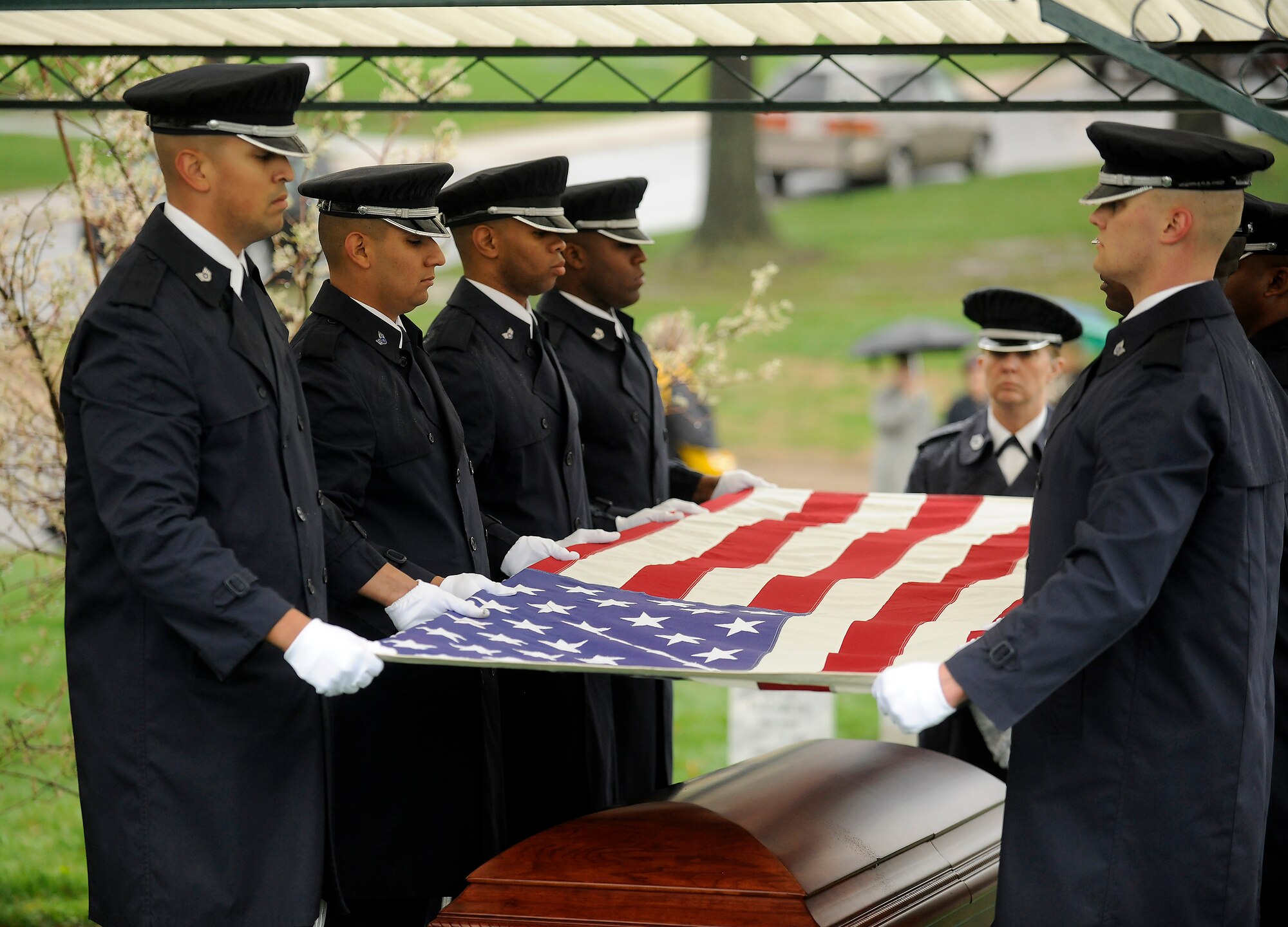 U.S. Air Force Honor Guard flag detail members prepare the U.S. flag March 29, 2010, that covered the casket of Maj. Gen. Jeanne M. Holm during her burial ceremony in Arlington National Cemetery. She was promoted to major general with an effective date of July 1, 1970, and was the first woman in the Armed Forces to serve in that grade. (U.S. Air Force photo/Scott M. Ash)