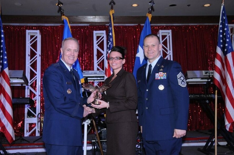 MINOT AIR FORCE BASE, N.D. -- Congratulations to Melissa L. Drago (center), 5th Force Support Squadron Child Development Center program technician. She won the Air Force-level award for the Airman and Family Services Flight (FSF) Technician of the Year. She was presented the award by Lt. Gen. Richard Y. Newton III (left), Deputy Chief of Staff for Manpower and Personnel, Headquarters U.S. Air Force, Washington, D.C., and Chief Master Sergeant of the Air Force James A. Roy. (Courtesy photo)