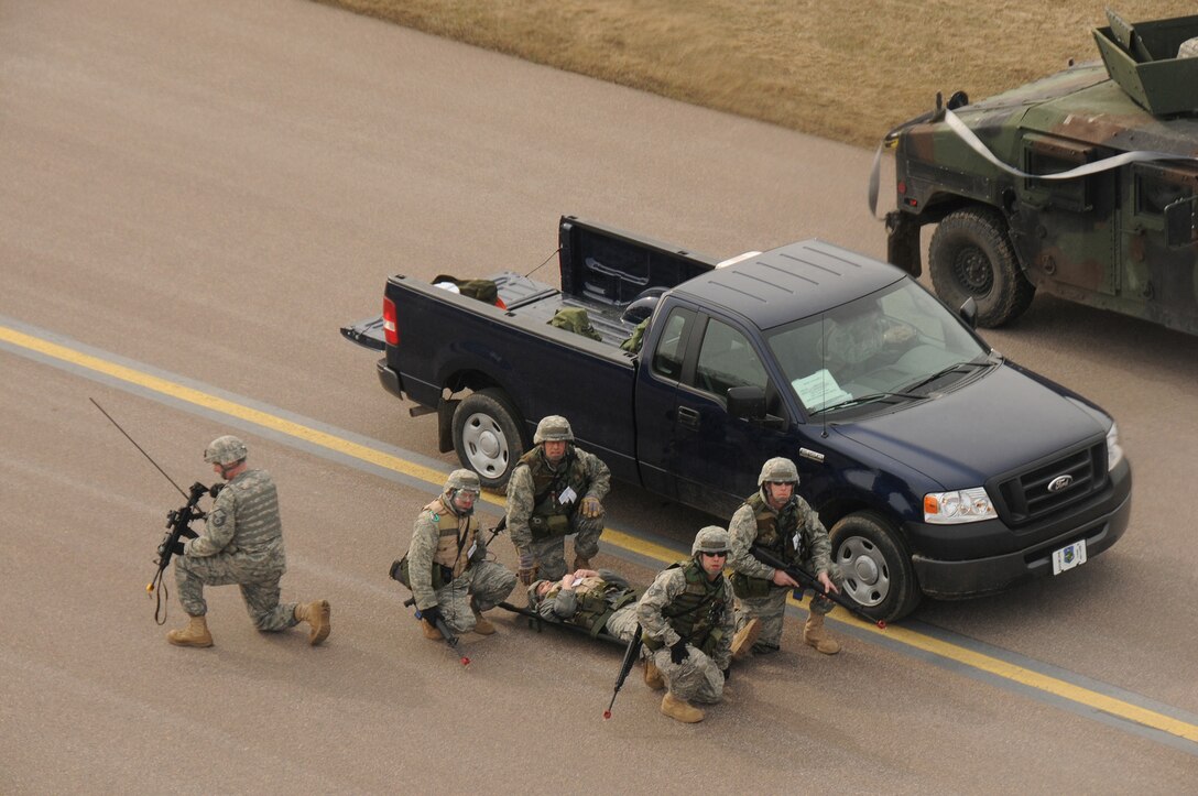 Members of the 158th Fighter Wing Civil Engineers await transportation for a medical evacuation at the Vermont Air National Guard Base, Burlington International Airport, March 25, 2010. The Airmen are participating in an Operational Readiness Inspection (ORI). (U.S. Air Force photo by SSgt Daniel DiPietro)