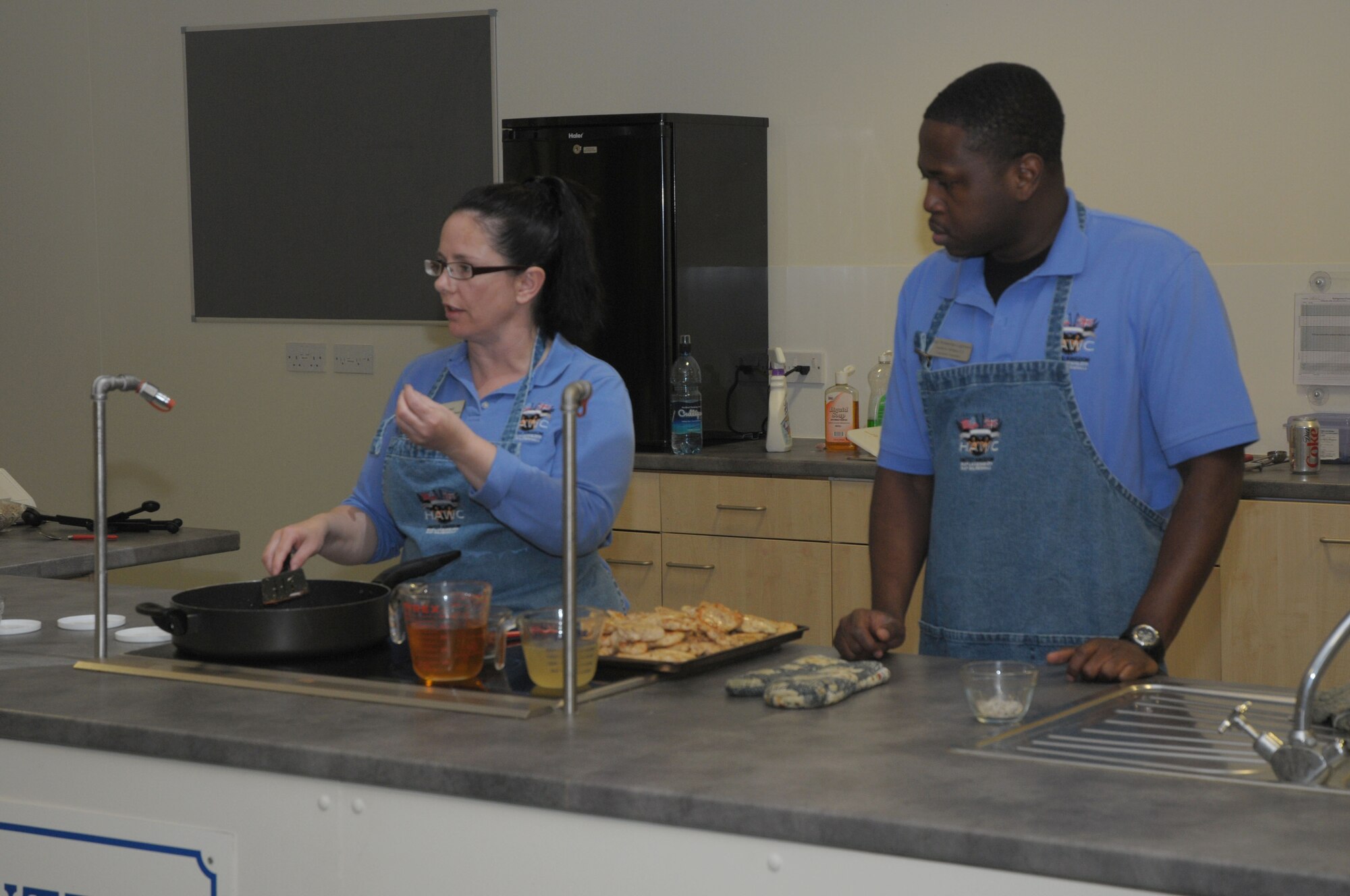 Master Sgt. Debra Downey (left), 48th Aerospace Medicine Squadron Flight chief of health promotions and Staff Sgt. Rontarrius Logwood, 48th AMDS Nutrition counselor, teaches how to cook healthy during the Woman’s History Month cooking class at RAF Lakenheath, England, March 25, 2010.  The healthy cooking class teaches people how to quickly cook with five ingredients and is demonstrated right in front of them, so they can understand how to cook quick, healthy food.