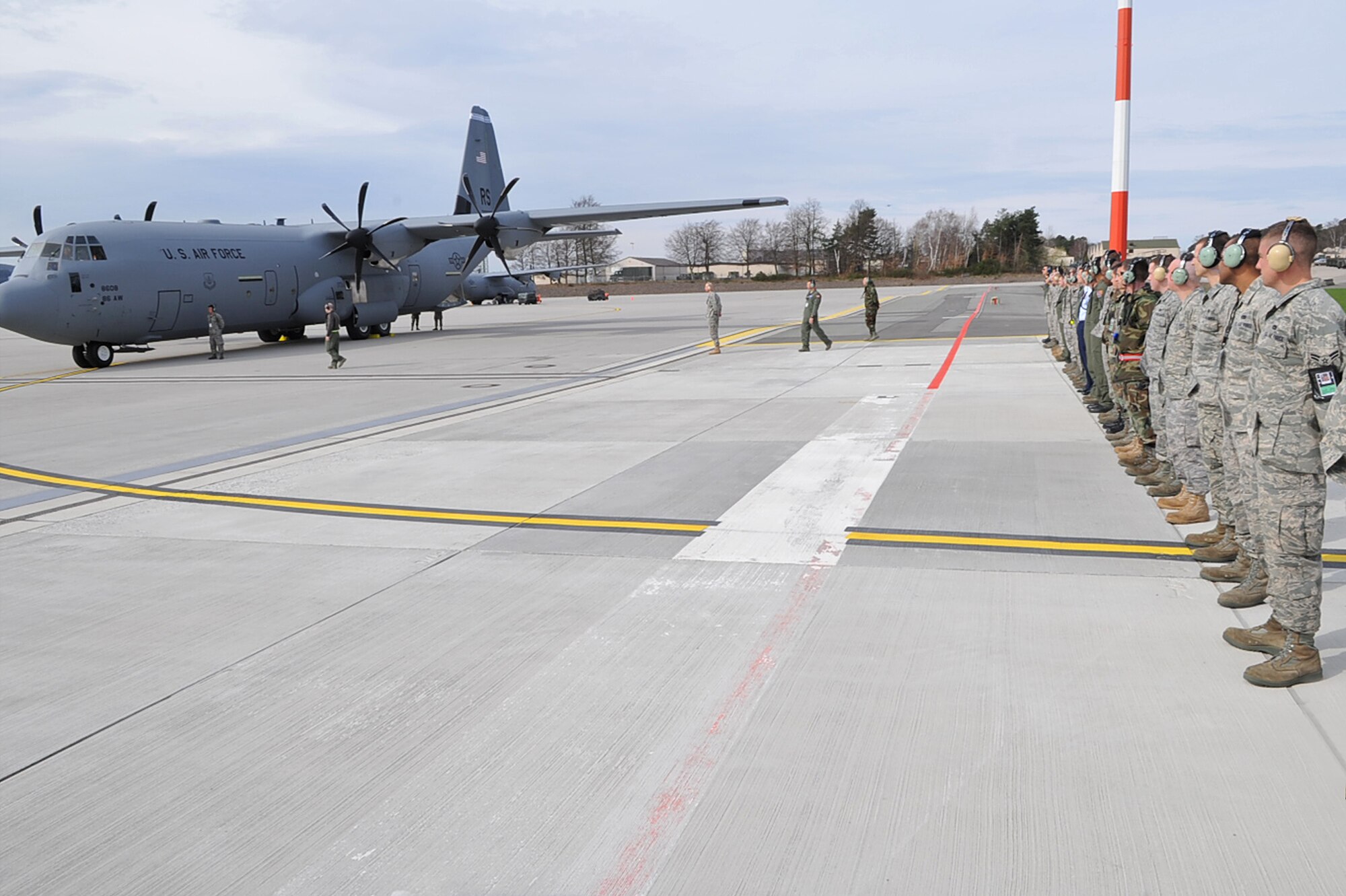The 13th C-130J Super Hercules is delivered by Maj. Gen. Jack Egginton, Director, Air and Space Operations, Headquarters U.S. Air Forces in Europe as Airmen from the 86th Aircraft Maintenance Squadron and 37th Airlift Squadron form a receiving line, Ramstein Air Base, Germany, March 30, 2010. Fourteen C-130J models will be assigned to Ramstein, replacing the older C-130Es as a part of the Air Force’s priority to revitalize the aircraft fleet. (U.S. Air Force photo by Senior Airman Tony R. Ritter)