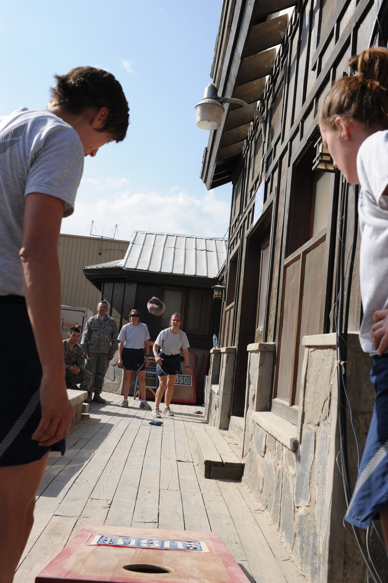 Members of Team Lifesaver, 455th Expeditionary Medical Group, attempt a bean bag toss at the Pat Tillman USO during The Amazing Race Afghanistan sponsored by the 455th Expeditionary Force Support Squadron morale, welfare and recreation office, March 28, 2010. Teams competed in nine different challenges around Bagram Airfield designed to test their mental and physical toughness.  (U.S. Air Force photo by/ Capt. Jean Duggan)