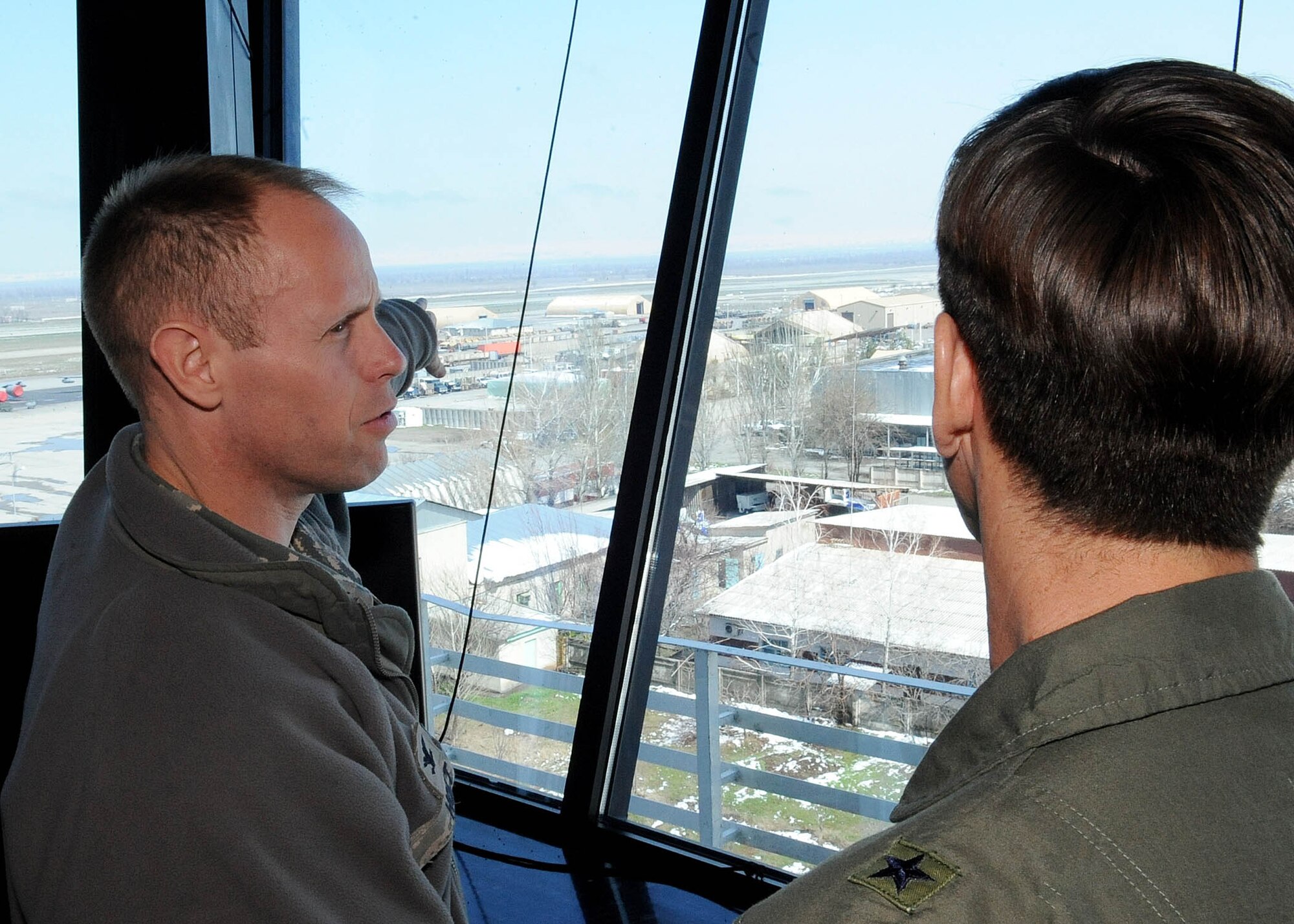 Col. Blaine Holt, 376th Air Expeditionary Wing commander, speaks with Brig. Gen. Joseph A. Lanni, Commander, Air Force Security Assistance Center about the expansion of the air field at Manas International Airport during a site visit to the Transit Center at Manas, Kyrgyzstan, March 28, 2010. (U.S. Air Force photo/Senior Airman Nichelle Anderson/released)