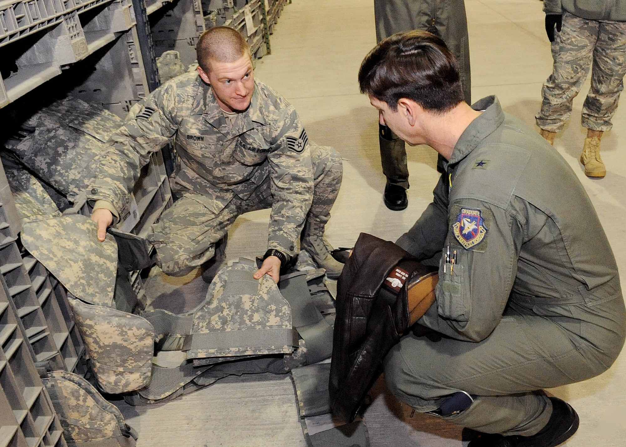 U.S. Air Force Staff Sgt. Dustin Brown, 376th Expeditionary Logistics Readiness Squadron Expeditionary Theater Distribution Center explains the new Improved Outer Tactical Vest to Brig. Gen. Joseph A. Lanni, Commander, Air Force Security Assistance Center during a site visit to the Transit Center at Manas, Kyrgyzstan, March 28, 2010. (U.S. Air Force photo/Senior Airman Nichelle Anderson/released)