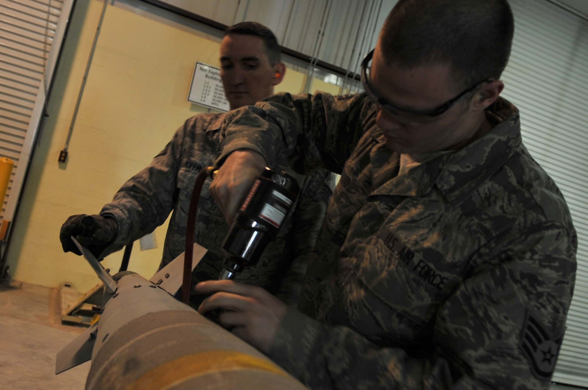 Staff Sgts. Phillip Mayo and William Hoffman, 332nd Expeditionary Maintenance Squadron munitions conventional maintenance crew members, install a fin on a GBU-38 Joint Direct Attack Munition at Joint Base Balad, Iraq, March 23, 2010. The 332nd EMXS Munitions Flight provides a full range of safe and reliable munitions to JBB aircraft, combat support, and battlefield Airmen. (U.S. Air Force photo/Senior Airman Brittany Y. Bateman/Released)