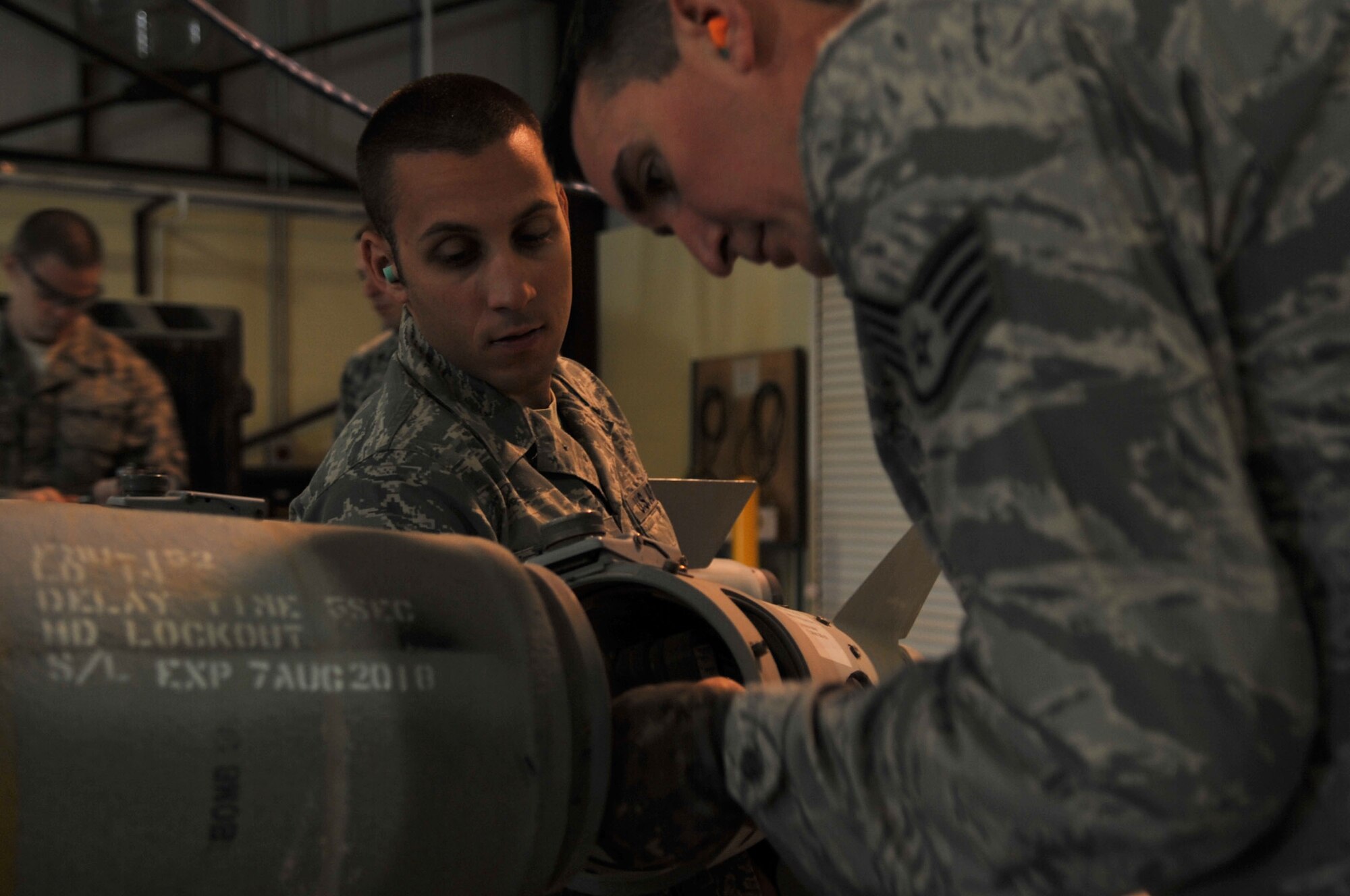 Staff Sgt. William Hoffman and Senior Airman Jamen Lomonaco, 332nd Expeditionary Maintenance Squadron munitions conventional maintenance crew members, install a fin on a GBU-38 Joint Direct Attack Munition at Joint Base Balad, Iraq, March 23, 2010. The 332nd EMXS Munitions Flight provides a full range of safe and reliable munitions to JBB aircraft, combat support, and battlefield Airmen. (U.S. Air Force photo/Senior Airman Brittany Y. Bateman/Released)