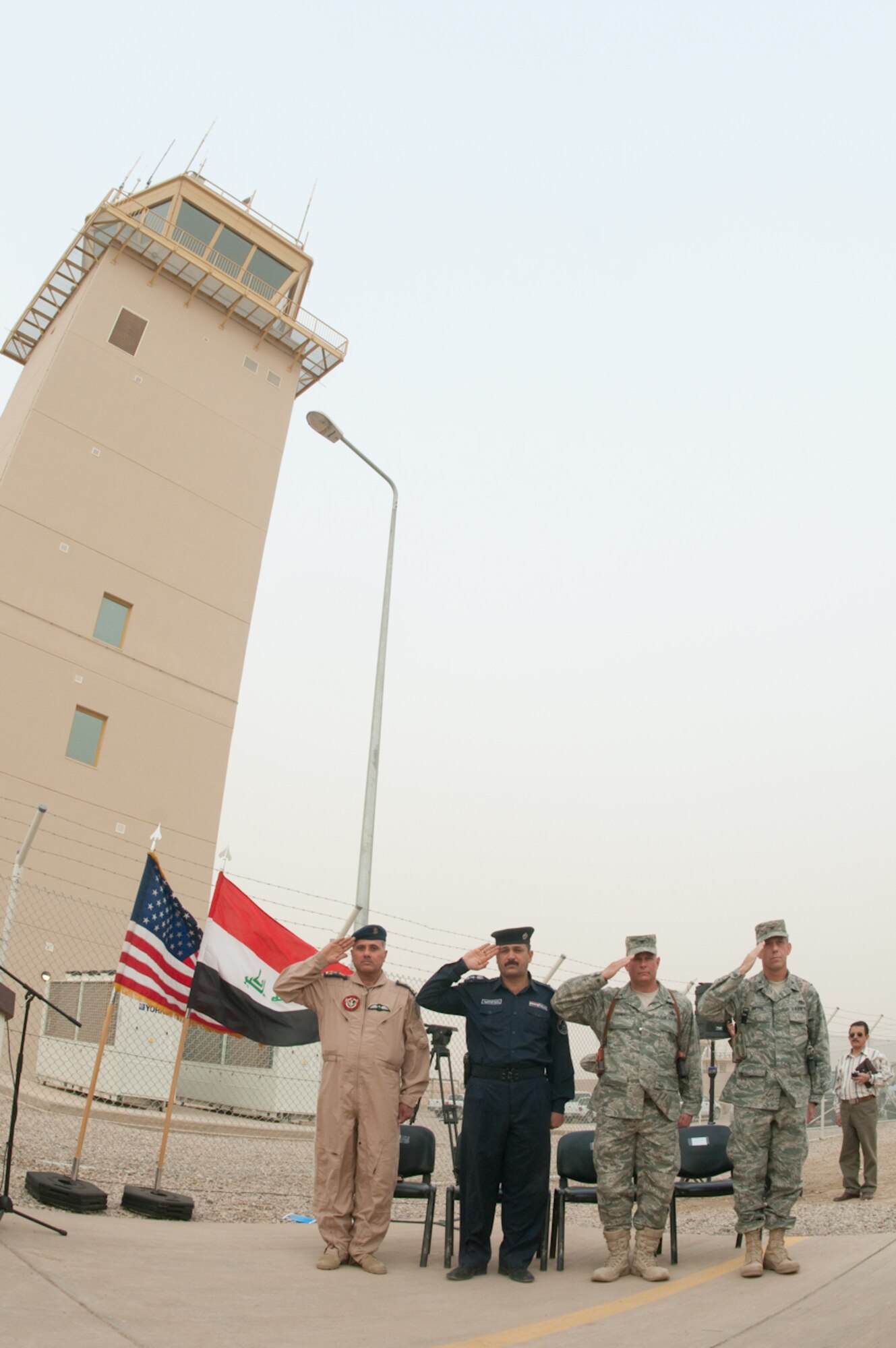 U.S. and Iraq Forces gathered together as they salute the flag during the
playing of the national anthems to celebrate the commemoration of the brand
new air traffic control tower, a $61.7 million project that brings Ali Base
capabilities to modern day standards here in Iraq, March 27, 2010. The
distinguished visitors included Brig. Gen. Sami (L), Iraq Air Force, Maj.
Gen. Sabah Al-Fatwawi, commanding general, Dhi Qar Province police chief,
U.S. Air force Cols. Lou Danner, commander, 407th Air Expeditionary Group,
Ali Base and Jeffry Knippel, commander, Gulf Region South, U.S. Army Corps
of Engineers. (U.S. Air Force photo by Senior Master Sgt. Elizabeth Gilbert)
