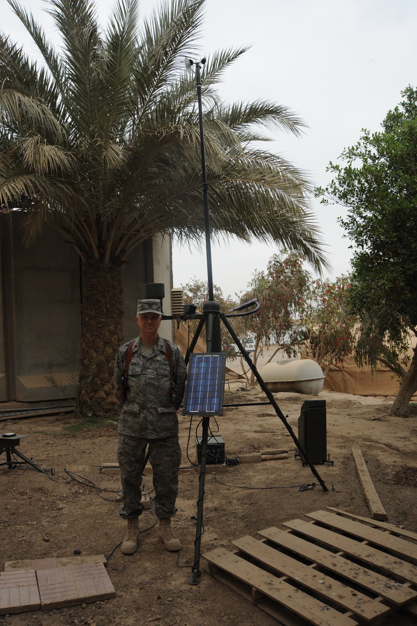 Air Force Major Barry Hunte, 321st AEAG/AOC weather advisor, stands next to the Tactical Meteorological Observation System that is used during the 52 day course during the graduation at the Air Force House, Camp Victory, Iraq, March 25, 2010. During this 52 day course, the eight Iraqi military students were instructed on everything from basic military observations to advanced weather forecast models. (U.S. Air Force photo/Master Sgt. Trish Bunting/Released)