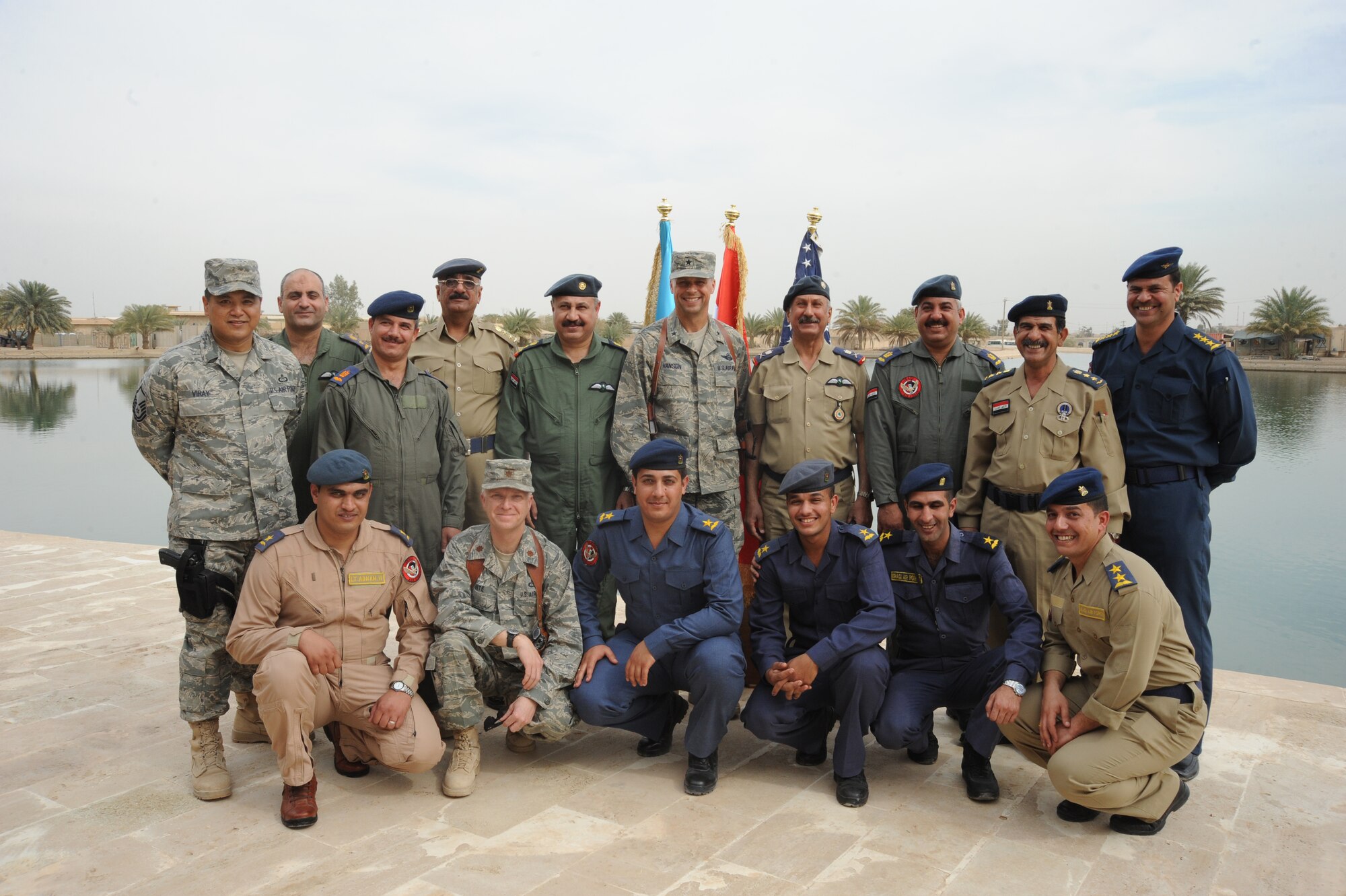 United States Air Force and Iraqi air force members from the first class of Iraqi air force meteorology officer’s graduation at the Air Force House, Camp Victory, Iraq, March 25, 2010. The graduates will be sent to diferent ocations throughout Iraq for 30 days of on-the-job training. Once the training is concluded, some of the weather advisory officers will become instructors while others will begin their weather advisory mission for the Iraqi military. (U.S. Air Force photo/Master Sgt. Trish Bunting/Released)