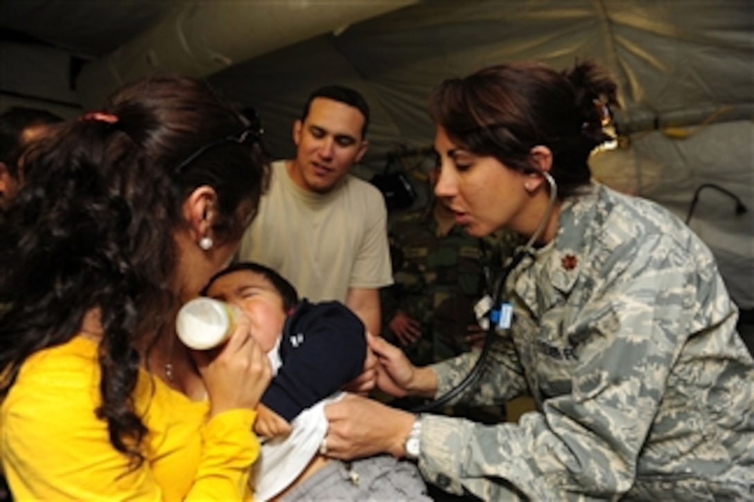 U.S. Air Force Maj. Deena Sutter, with the 59th Medical Wing, Lackland Air Force Base, Texas, listens to a child's heart in Angol, Chile, on March 14, 2010.  Airmen with an Air Force expeditionary medical support team and members of the Chilean Army assembled a mobile hospital to help augment medical services for nearly 110,000 Chileans in the region.  