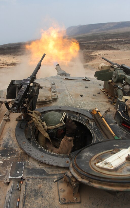 Lance Cpl. William Laffoon, tank crewman with Tank Platoon, Battalion Landing Team 1st Battalion, 9th Marine Regiment, 24th Marine Expeditionary Unit, braces himself after firing a 120mm round from an M1A1 Abrams battle tank during a live-fire range in Djibouti, Africa, March 30.  The Marine tanks engaged several targets alongside the French Foreign Legion’s 13th Demi-Brigade as part of a bi-lateral training exercise where both countries militaries learned about each other’s armored capabilities.  The 24th MEU performed a series of sustainment and bi-lateral training exercises alongside the French military during a month-long rotation of troops from the 24th MEU in Djibouti.  The 24th MEU deployed in January aboard Navy ships of the Nassau Amphibious Ready Group, and is currently serving as the theatre reserve force for Central Command.  The training in Djibouti is one of the various training exercise the 24th MEU is conducting while in CENTCOM.  (U.S. Marine Corps photo by Sgt. Alex C. Sauceda)