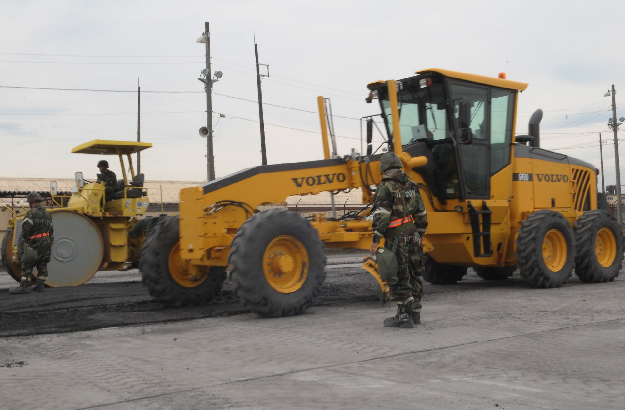 YOKOTA AIR BASE, Japan -- Members from the 374th Civil Engineering Squadron, repair a section of a road during an exercise scenario.  The exercise tested Yokota Airman’s operational readiness preparedness. (U.S. Air Force photo/Airman 1st Class Devin Doskey)