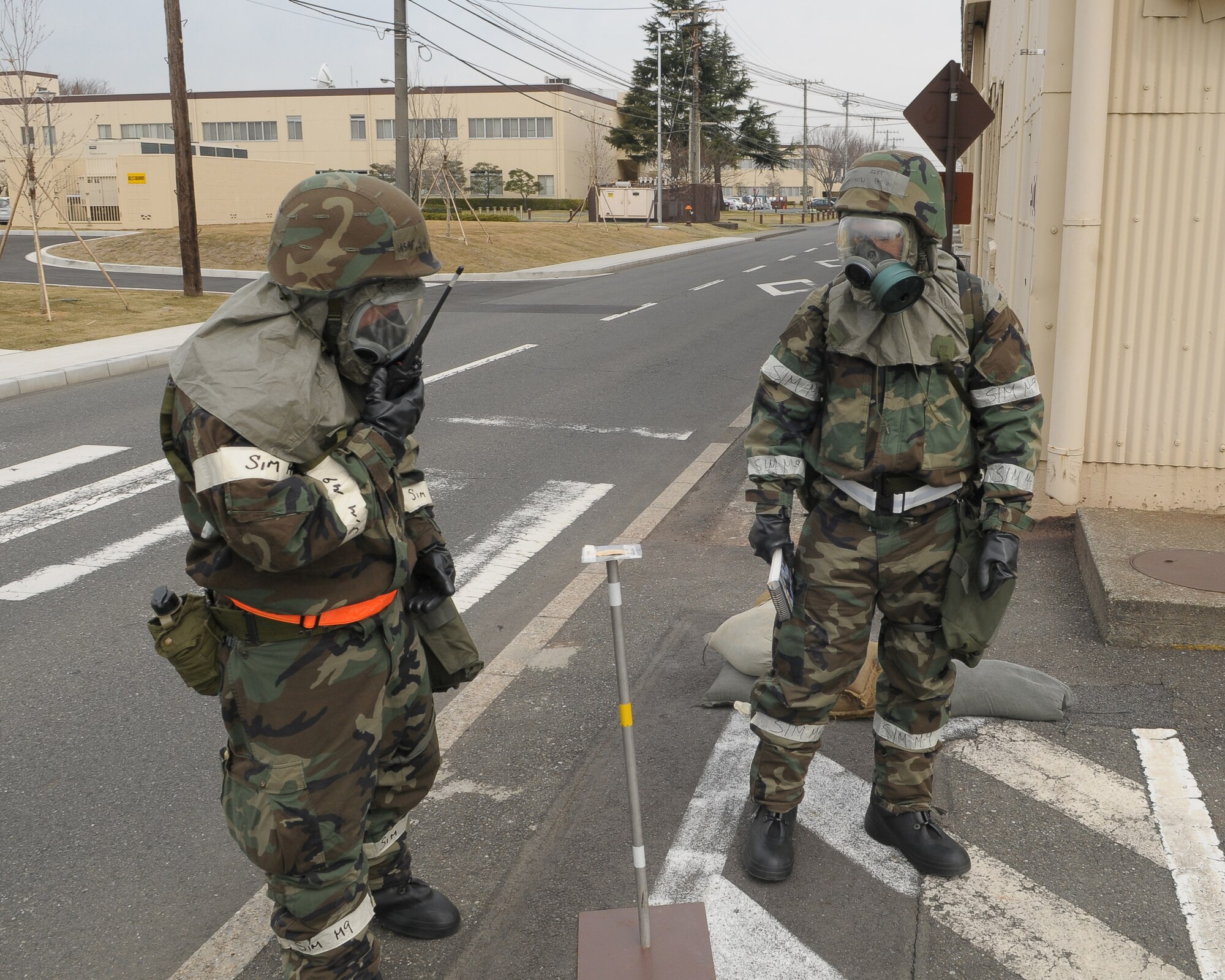 YOKOTA AIR BASE, Japan -- Members of the 374th Logistics Readiness Squadron conducts a post attack reconnaissance sweep around their building here Mar. 31. The exercise tested Yokota Airman’s operational readiness preparedness. (U.S. Air Force photo/Airman 1st Class Devin)
