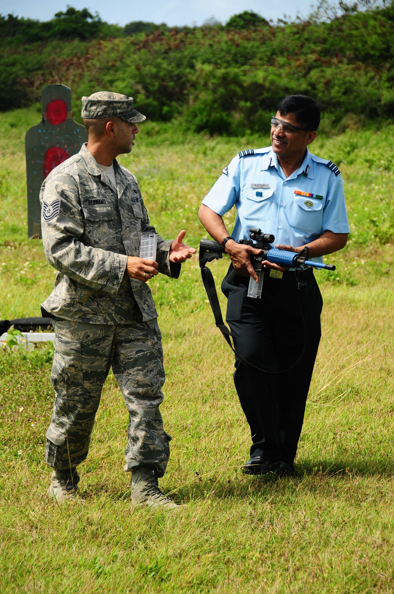ANDERSEN AIR FORCE BASE, Guam ? Tech. Sgt. Marcus Serrano from the 736th Security Forces discusses small arms firing technique with a visitor from India as part of the Subject Matter Expert Exercise, here on March 24. Papa New Guinea, Mongolia, India, and the Philippines were among the nations represented to exchange ideas on security matters pertaining to air base defense. (U.S. Air Force photo by A1C Jeffrey Schultze)