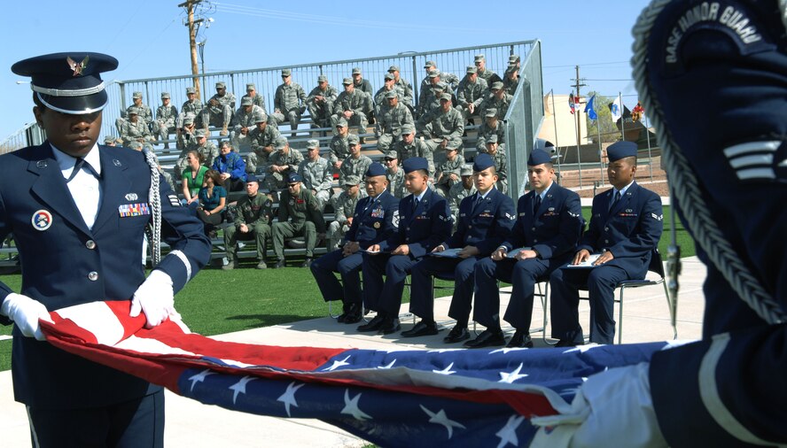 HOLLOMAN AIR FORCE BASE, N.M. -- Members of the Steel Talons Honor Guard fold a U.S. flag to honor Airmen at a Naturalization Ceremony, March 26, 2010 at Heritage Park. Since September 2001, more than 53,000 U.S. armed forces members have been naturalized by the U.S. Citizenship and Immigration Services. (U.S. Air Force photo by Airman 1st Class Joshua Turner)(Released)