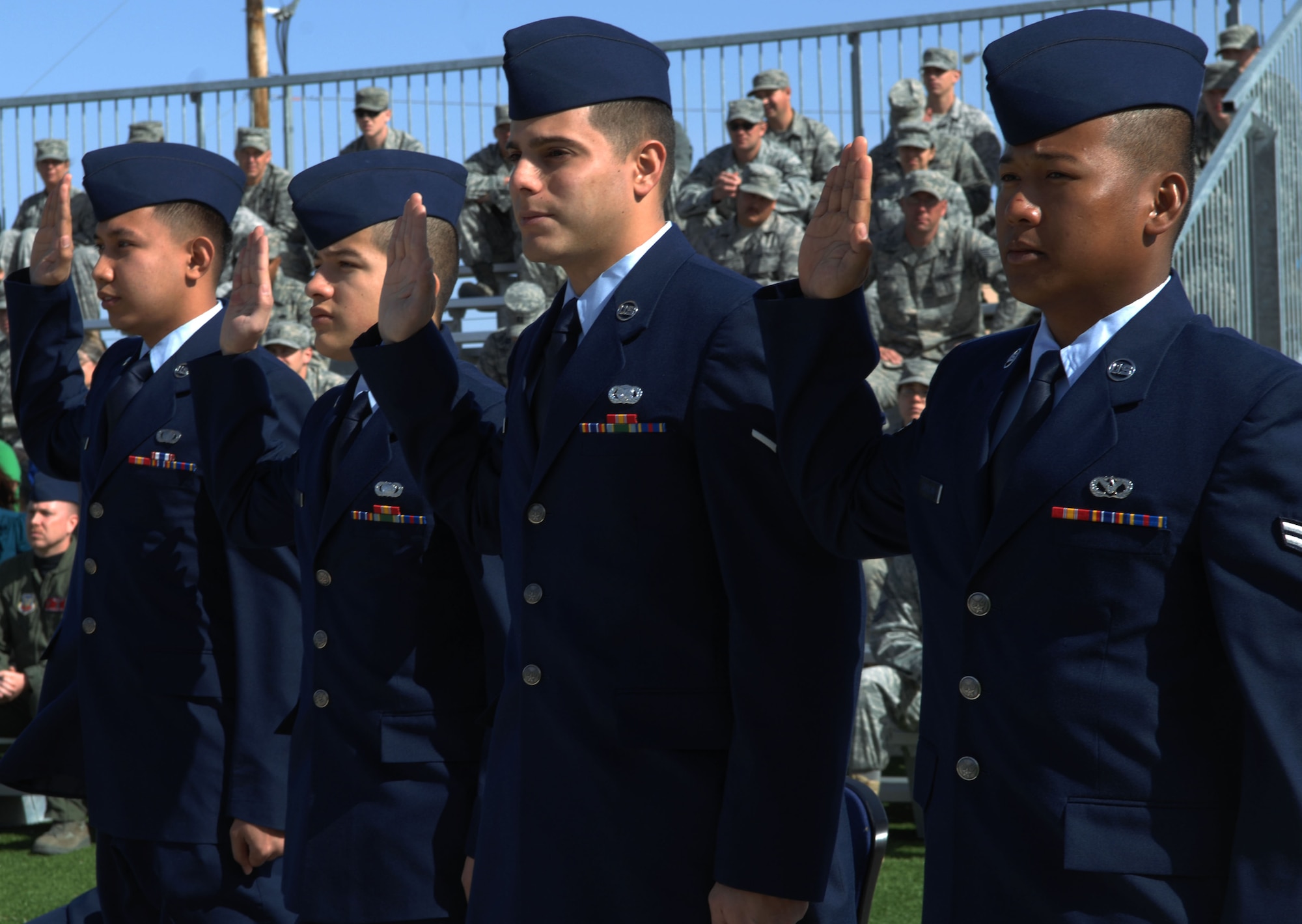 HOLLOMAN AIR FORCE BASE, N.M. -- Airmen raise their right hand and recite the oath of citizenship during a Naturilization Cermony, March 26, 2010. Since September 2001, more than 53,000 U.S. armed forces members have been naturalized by the U.S. Citizenship and Immigration Services. (U.S. Air Force photo by Airman 1st Class Joshua Turner)(Released)