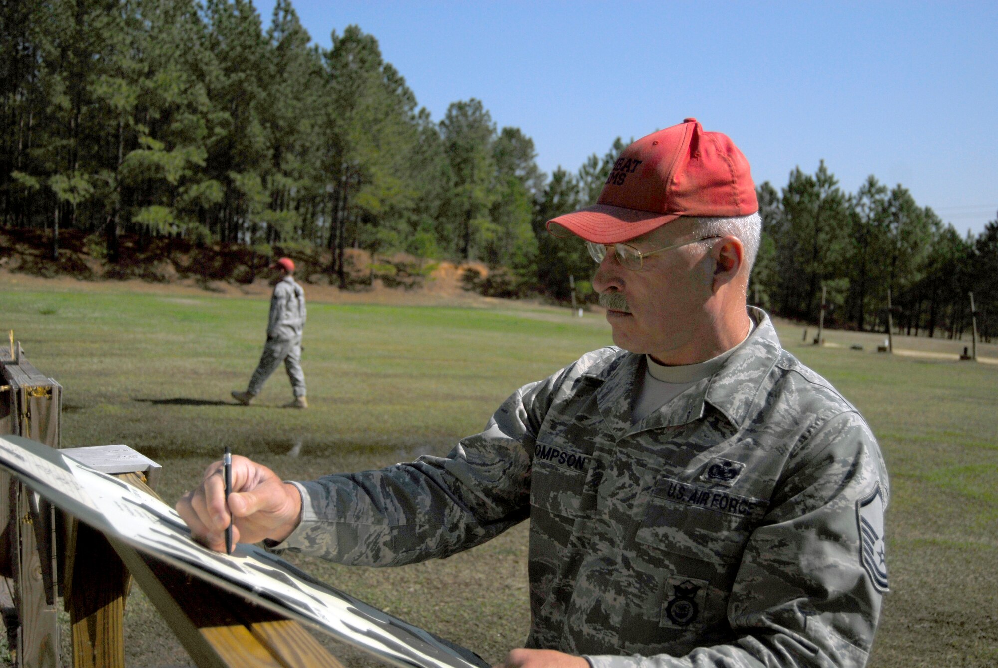 Master Sgt. Tommy Thompson, 440th Security Forces Squadron Combat Arms Instructor, grades a target after a live-fire Combat Arms training course March 30. The training allows students to demonstrate their proficiency with combat arms, which is a vital skill required for servicemembers in a deployed location. (U.S. Air Force photo/Senior Airman Quentin Irvin)