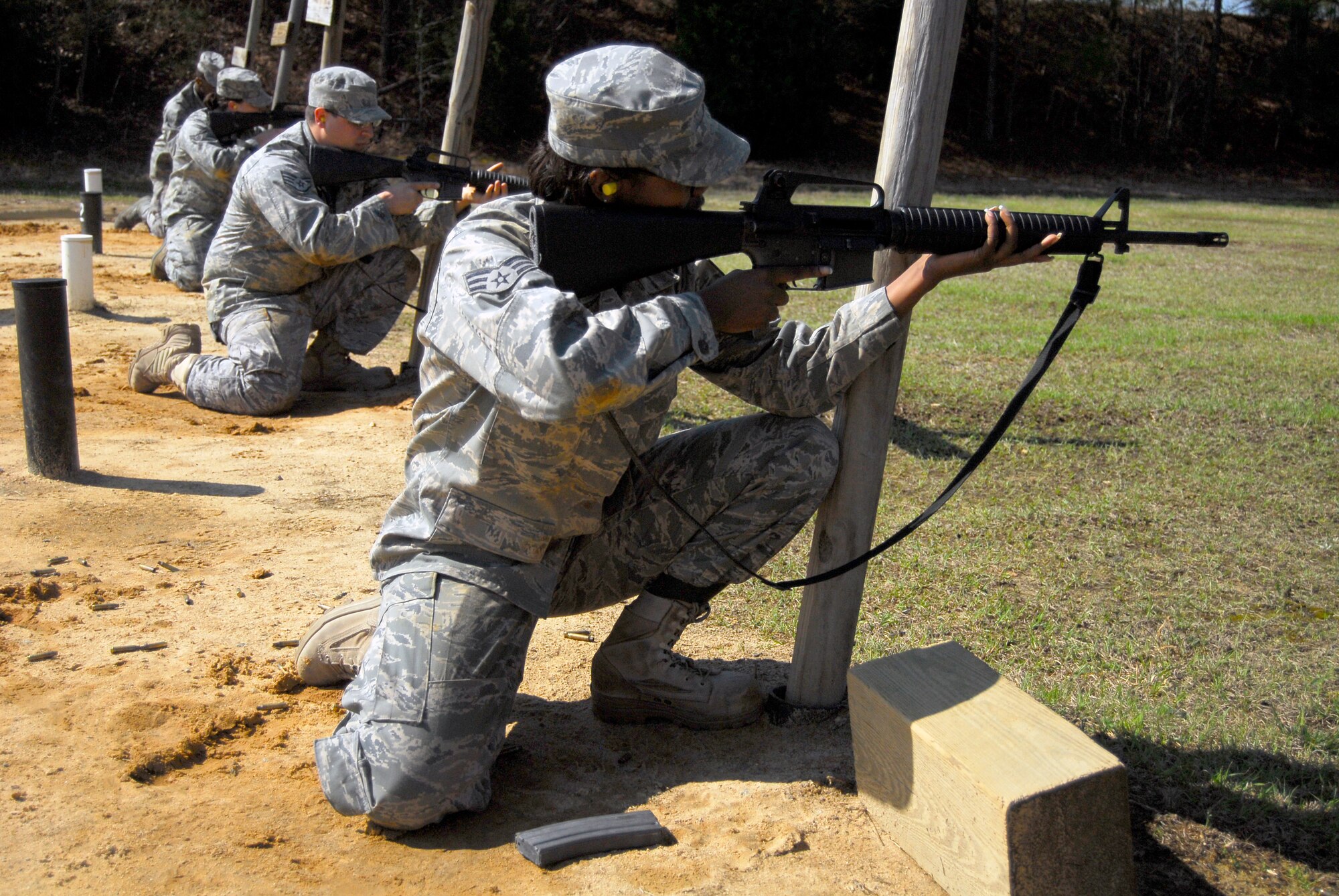 Students on the firing line stand by to lock and load during the Combat Arms training course at the firing range March 30. The students are required to shoot in several different firing positions in order to remain proficient for real world combat. (U.S. Air Force photo/Senior Airman Quentin Irvin)