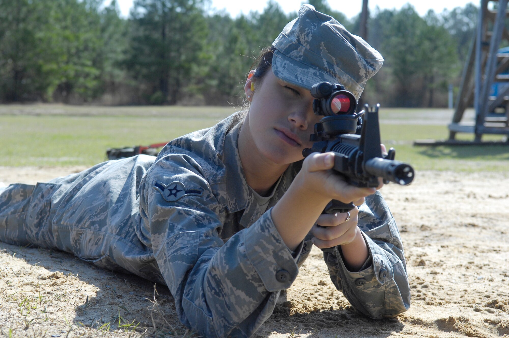 Airman Kathleen Honan, 43rd Airlift Wing, focuses her sight on a target during a rifle skills class March 30. Airman Honan is firing in the prone unsupported position as part of her qualification for the M-4 rifle. (U.S. Air Force photo/Senior Airman Kris Levasseur)