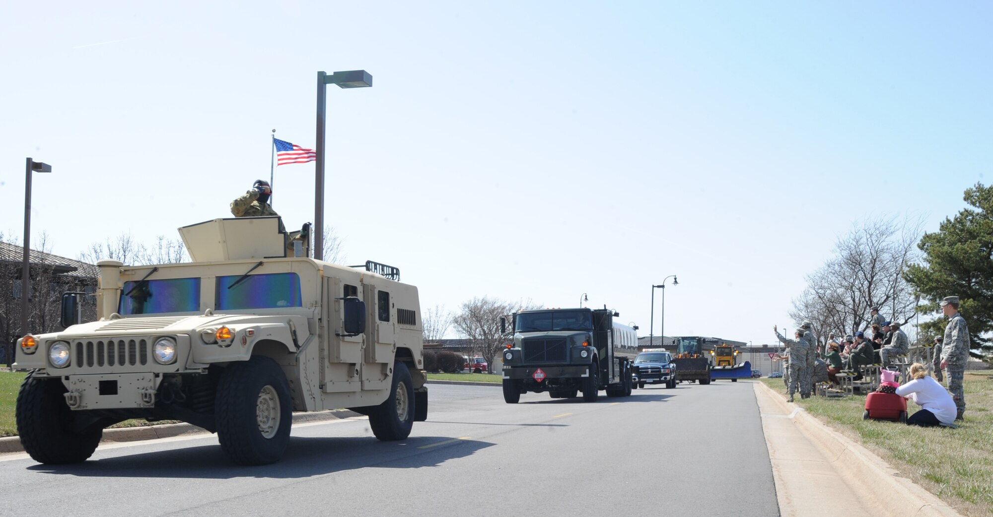 A Humvee, along with 39 other 22nd Mission Support Group emergency and mobility vehicles, parade through the base for Team McConnell members during a pass-in-review, March 26, 2010, McConnell Air Force Base, Kan. The display demonstrated a variety of equipment that enables the 22nd MSG to support the base’s mission and achieve  the wing’s priorities of “Ready mobility… Ready Airmen… Ready base.” (U.S. Air Force photo/Senior Airman Maria Ruiz) 