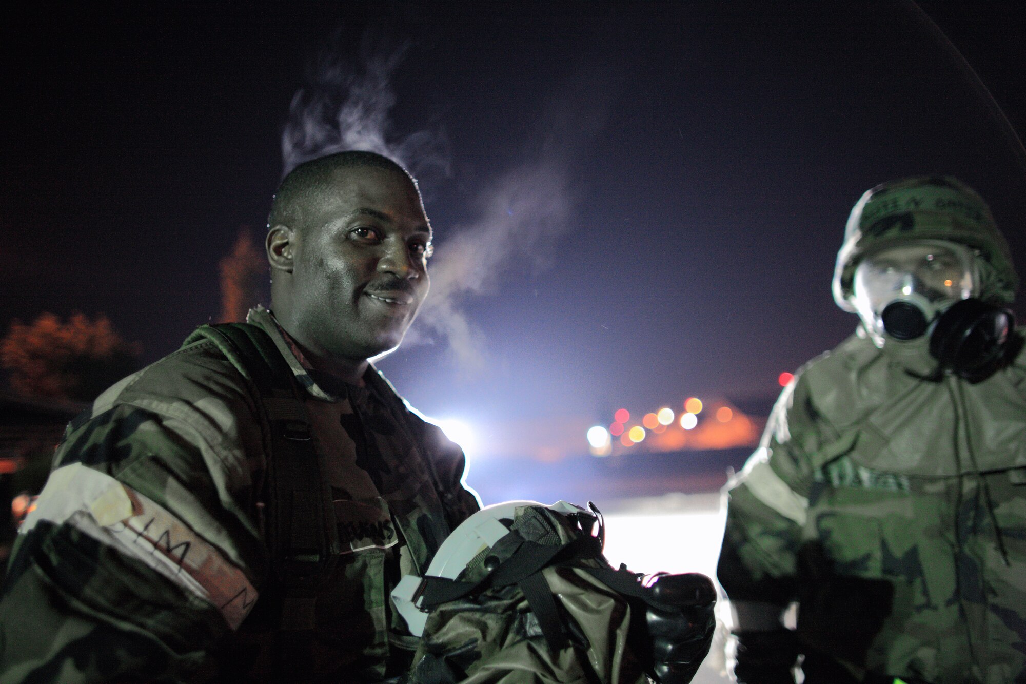 YOKOTA AIR BASE, Japan -- Staff Sgt. Sadiq Stevens, 374th Operation Support Squadron, has steam rising off him after removing his gas mask after completion of an exercise scenario here Apr.1. Yokota conducted an exercise 28 Mar. through 1 Apr. to help maintain operational readiness. (U.S. Air Force photo/Osakabe Yasuo)