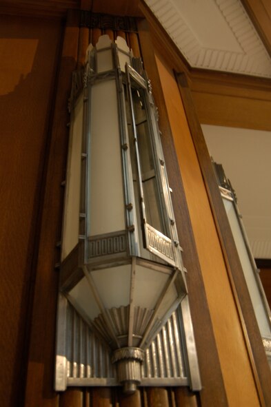 An old light fixture still hangs on the rich woodwork in the rotunda of building 12.  The building was the old Army Aeronautical Museum that was built by the Quartermaster Corps U.S. Army in 1935. (U.S. Air Force photo by Ted Theopolos)