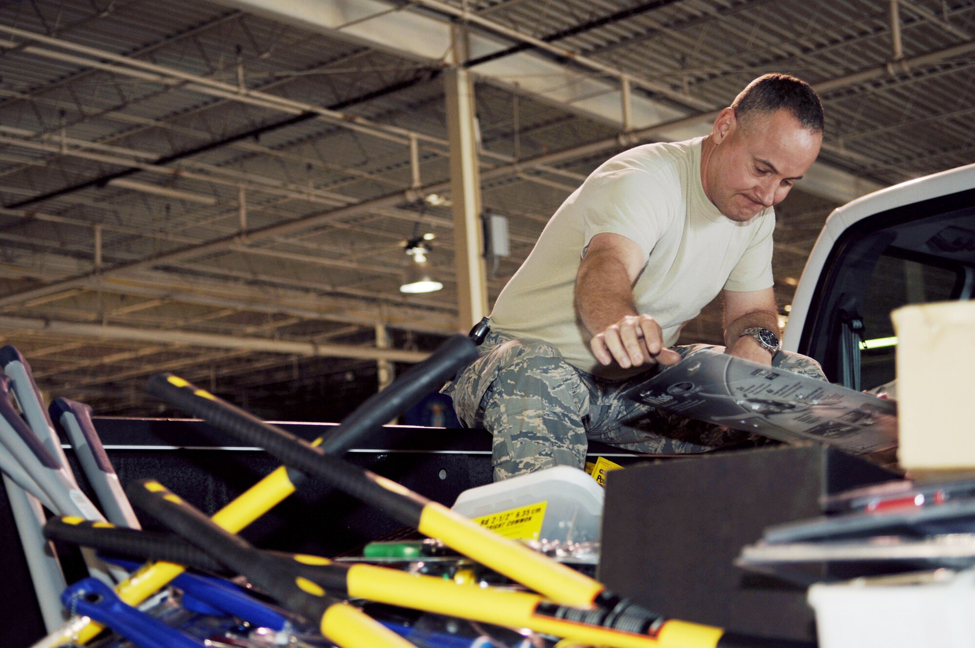 Master Sgt. Michael Means arranges tools for a relief package that was sent to Chile March 16, 2010, at Holloman Air Force Base, N.M. More than $13,000 was spent in the local community at local hardware stores purchasing the equipment. Sergeant Means is the 49th Civil Engineer Squadron heavy superintendent. (U.S. Air Force photo/Airman 1st Class Joshua Turner)